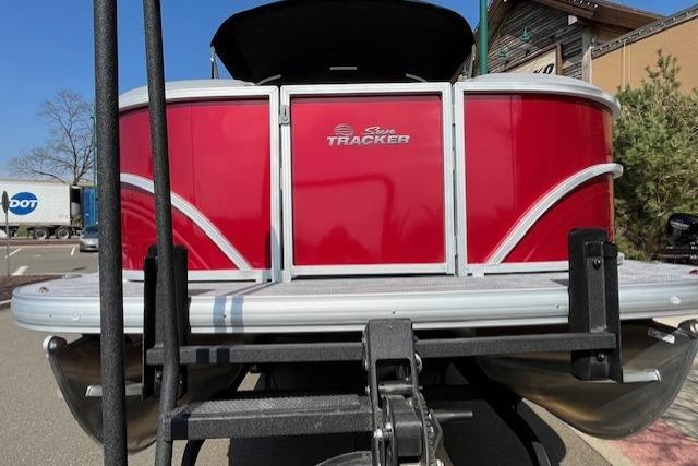 2026 Sun Tracker Party Barge 20 DLX pontoon boat, red exterior, on trailer.