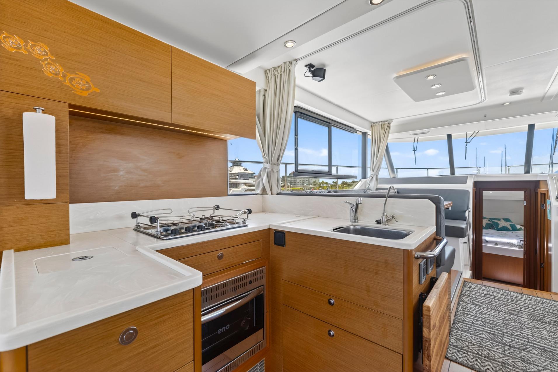 Modern kitchen interior of 2022 Beneteau Swift Trawler 41 Fly yacht.