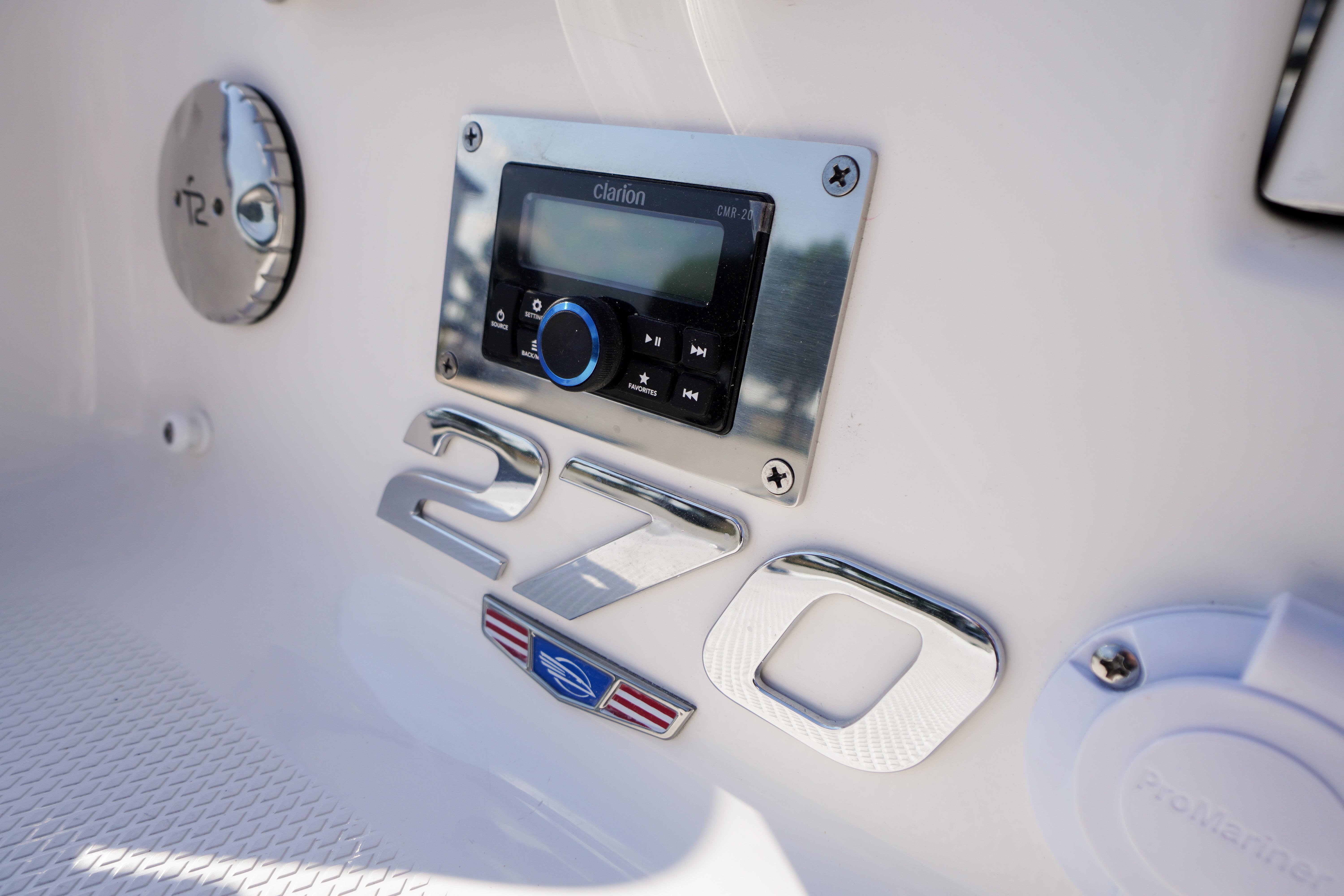 2026 Chaparral 270 OSX boat dashboard with Clarion audio system and model emblem.
