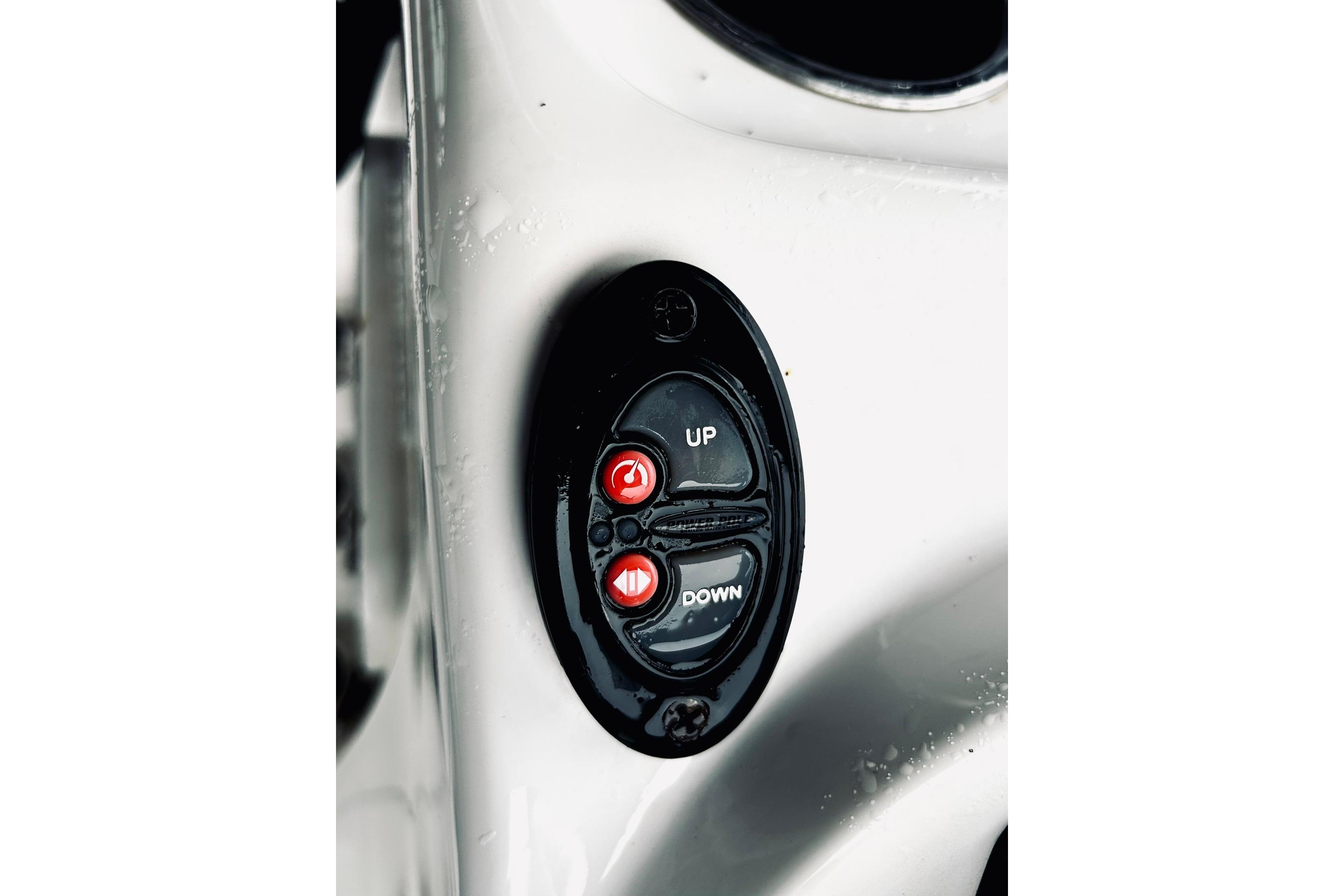 Control panel on a 2017 Blue Wave 2200 PureBay boat, featuring up and down buttons.