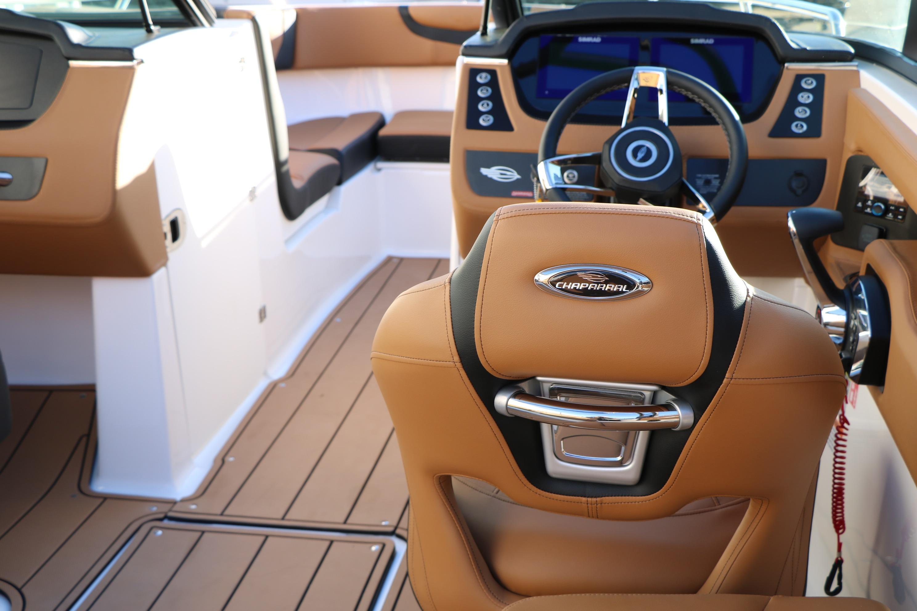 2026 Chaparral 247 SSX boat interior with tan leather seats and modern dashboard.