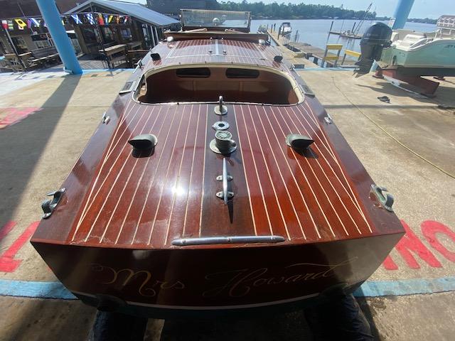 Grand Craft Classic Runabout 2000, wooden boat docked by the waterfront.