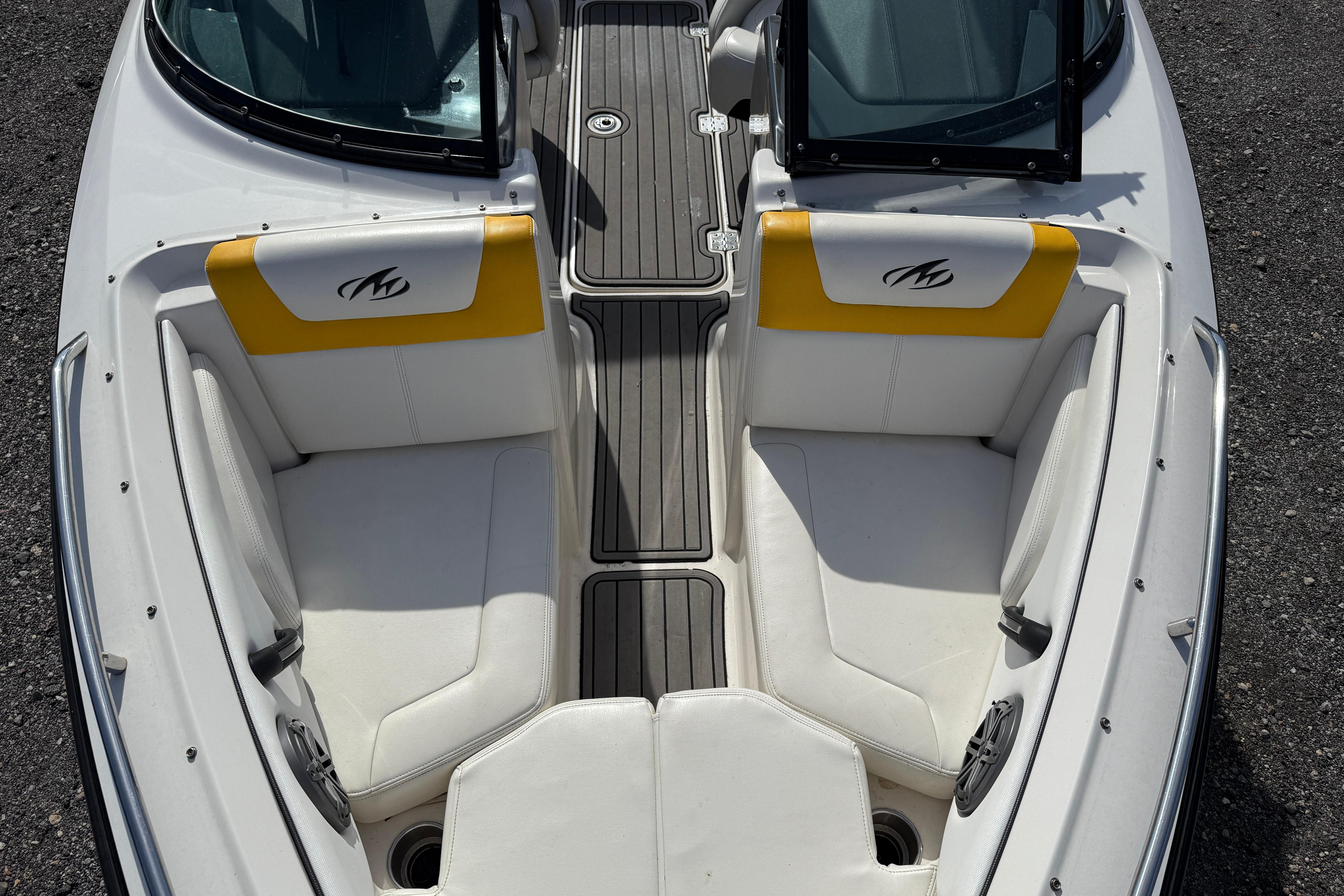 2014 Monterey 197 Blackfin boat interior with white and yellow seating, open windshield.