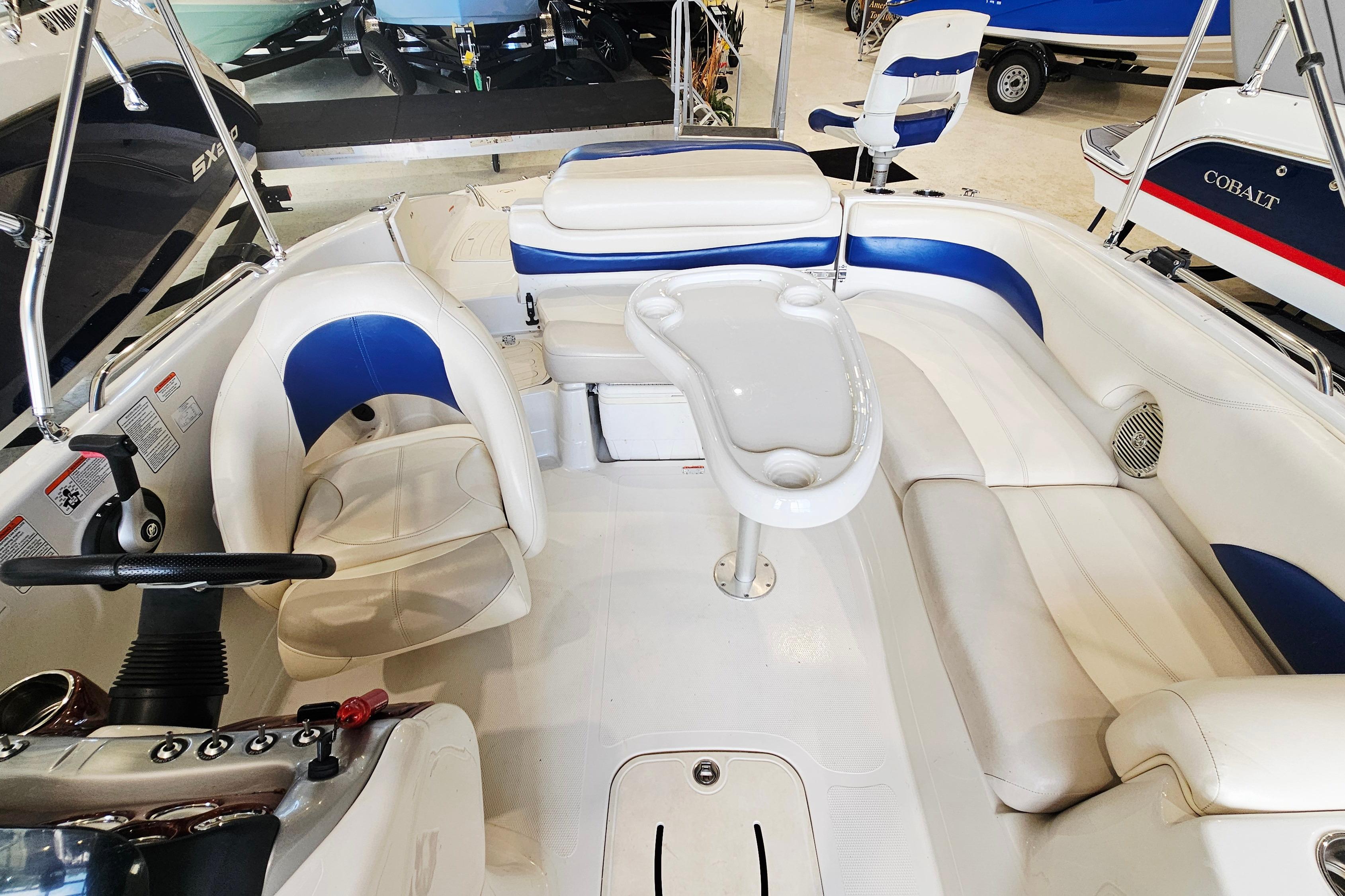 Interior of a 2012 Tahoe 215 Xi boat with white and blue seating.