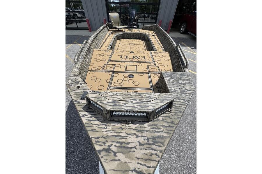 2026 Excel 183 Tomahawk boat with camouflage design, parked outdoors.
