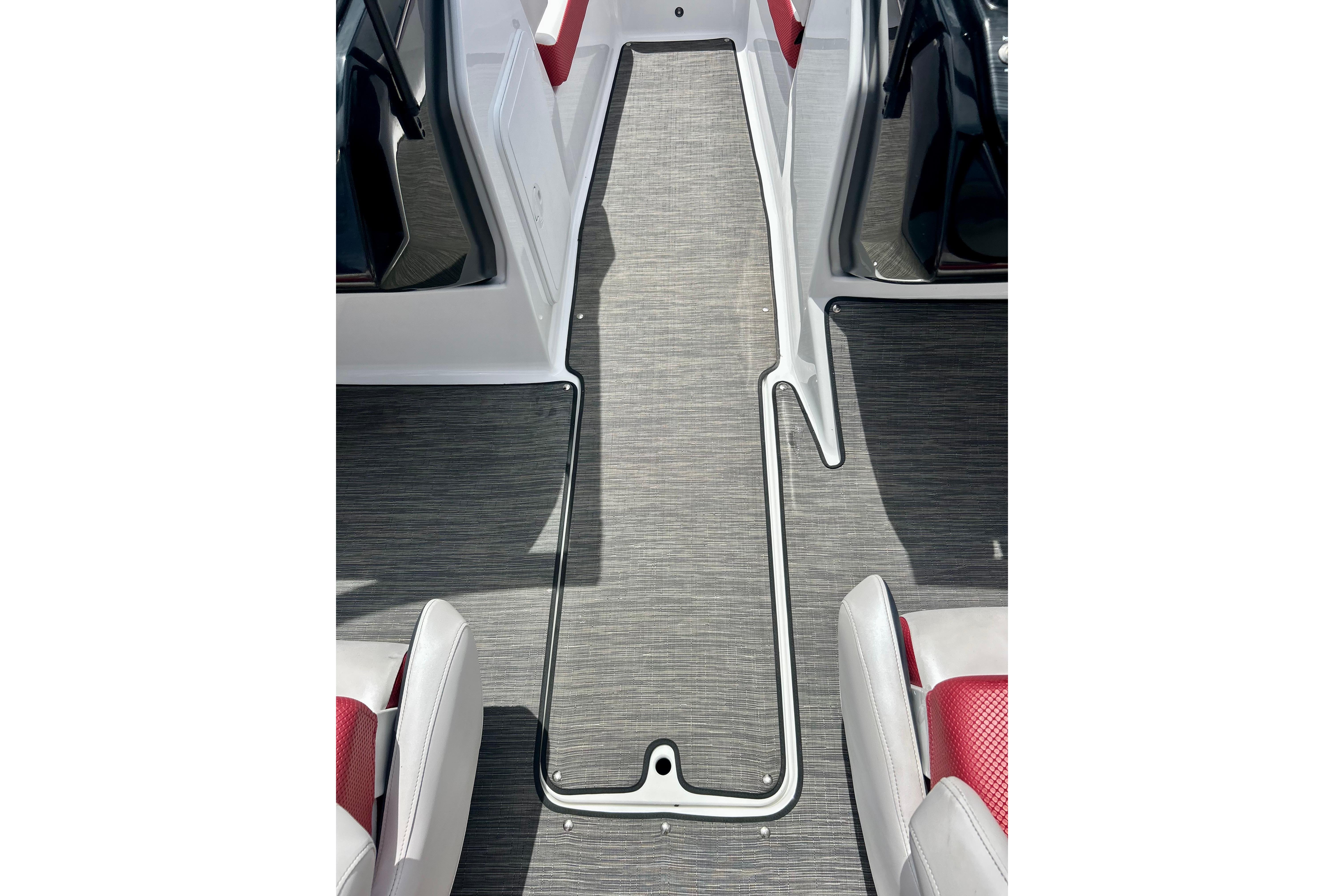 Interior view of 2021 Scarab 195 ID boat with sleek flooring and seating.