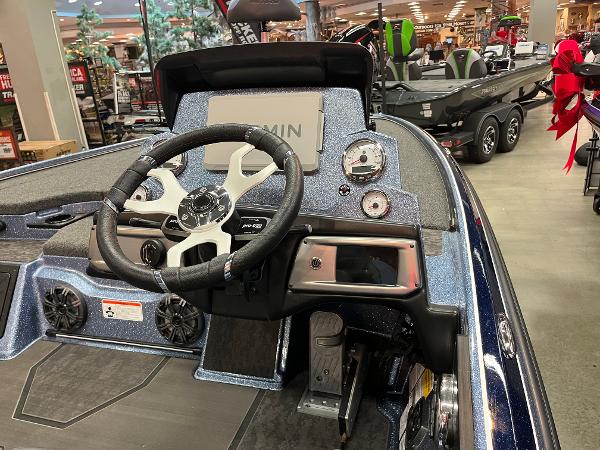 2025 Nitro Z20 XL Pro boat dashboard with steering wheel and gauges in showroom.