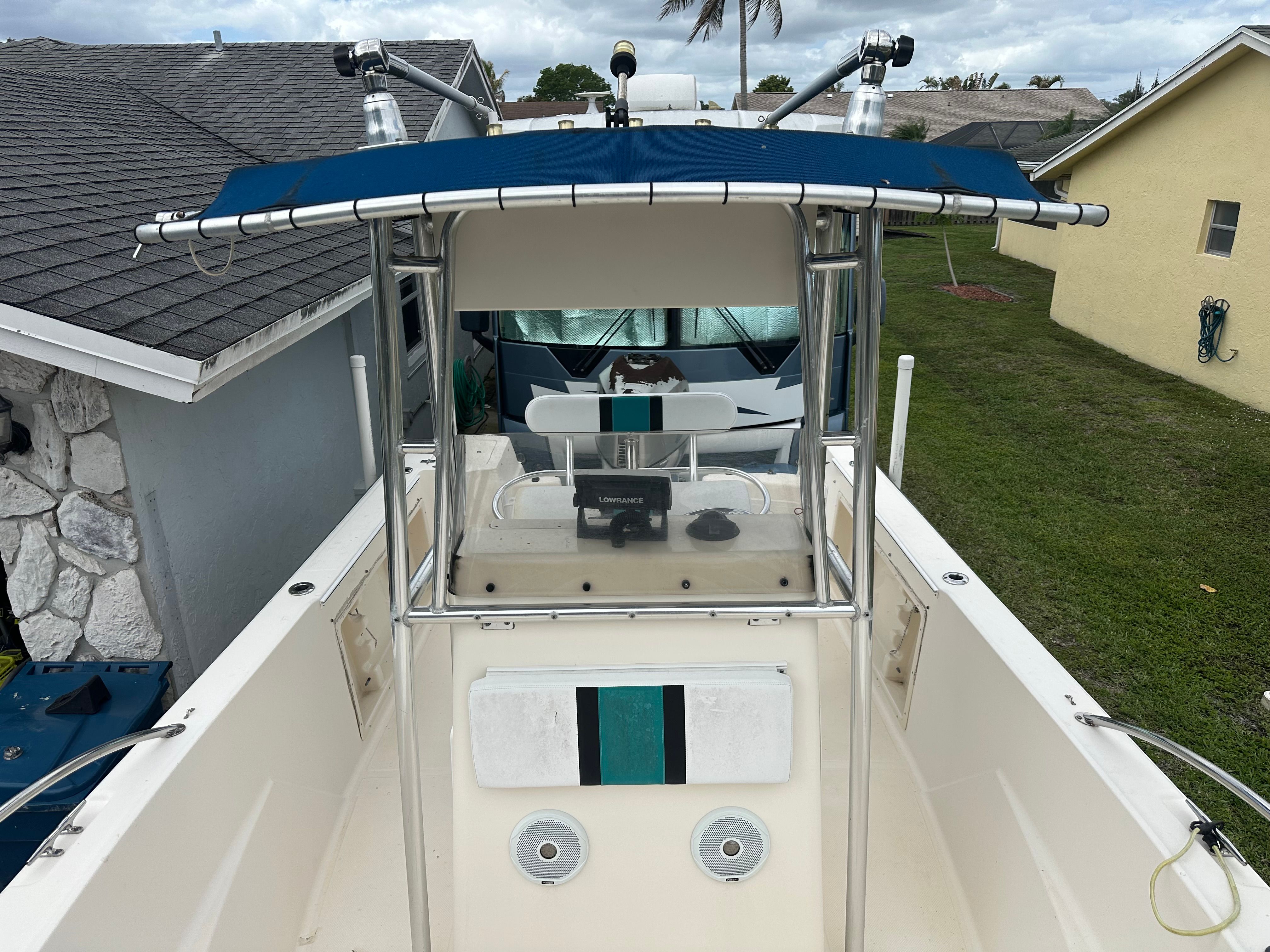 A 2004 Key West Blue Water 225cc boat with T-top and helm console.