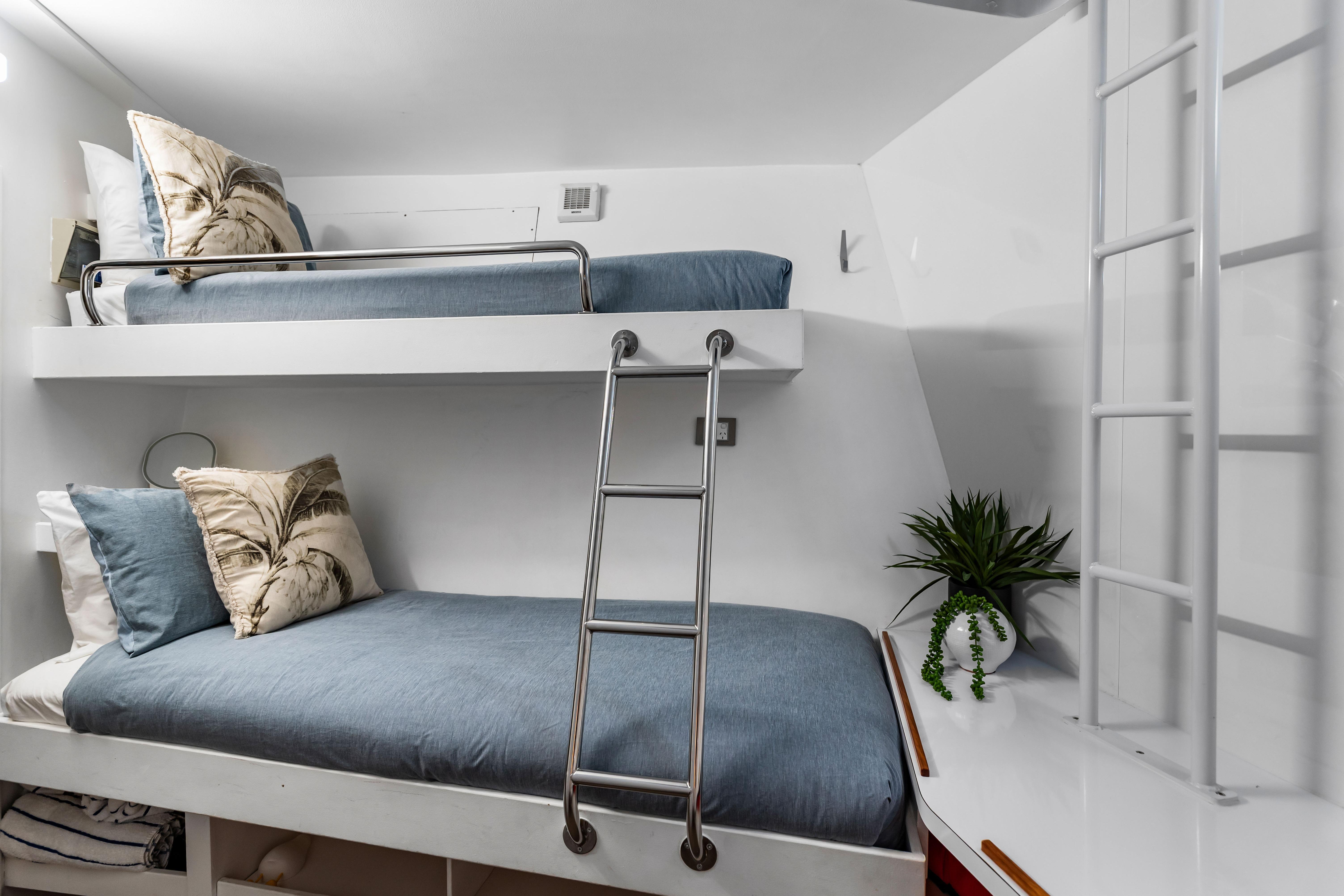 Bunk beds in a 2012 Custom 25m Long Range Expedition Charter Yacht cabin, featuring modern decor.