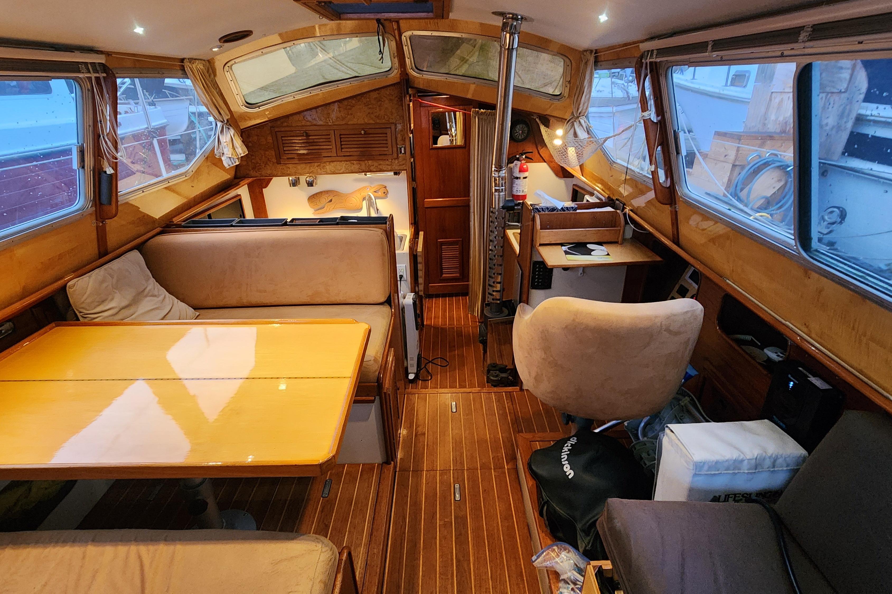 Interior of a 1986 Saturna 33 Pilot boat with wooden furnishings and seating area.