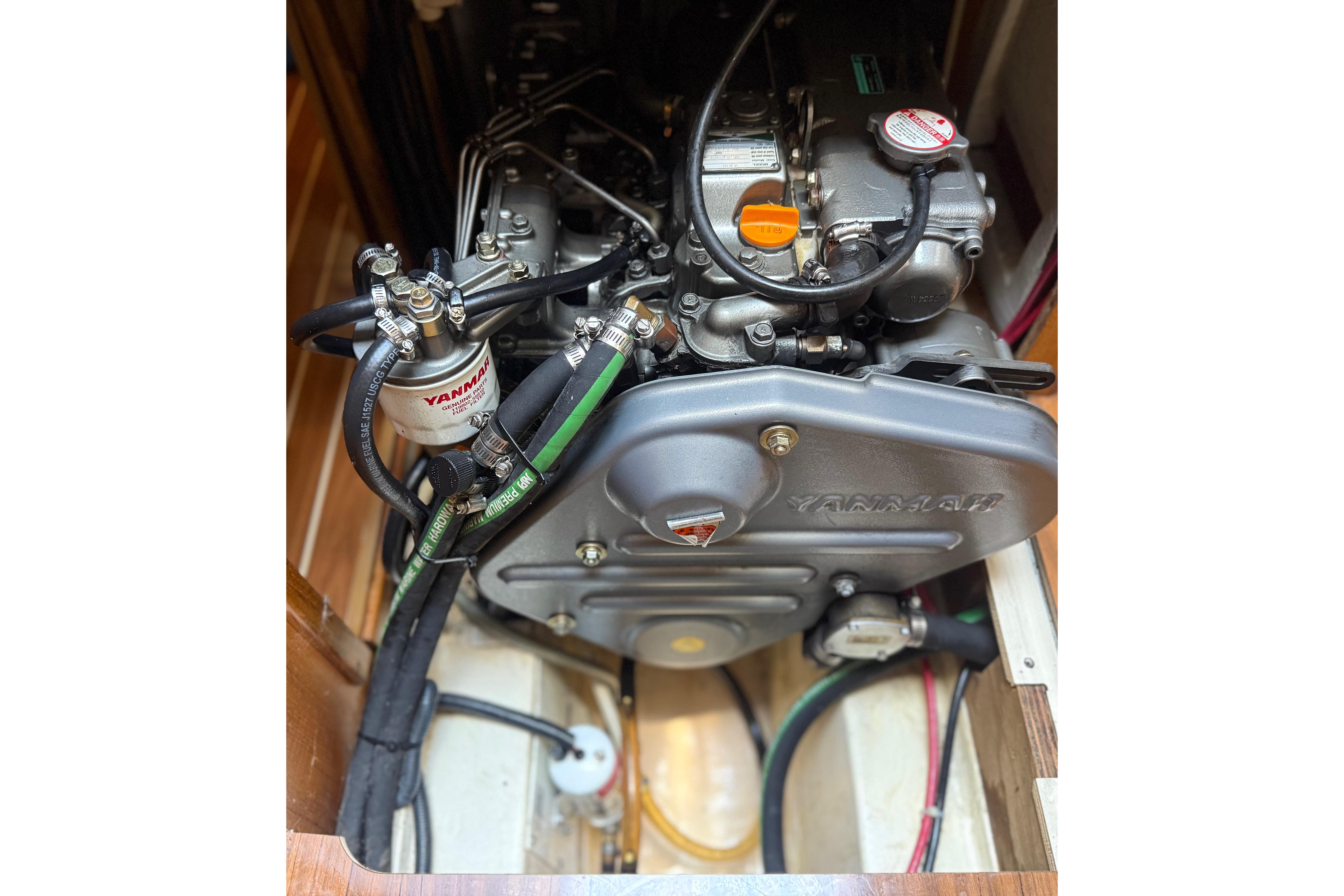 Engine compartment of a 2007 Hunter 41 Deck Salon sailboat, featuring a Yanmar engine.