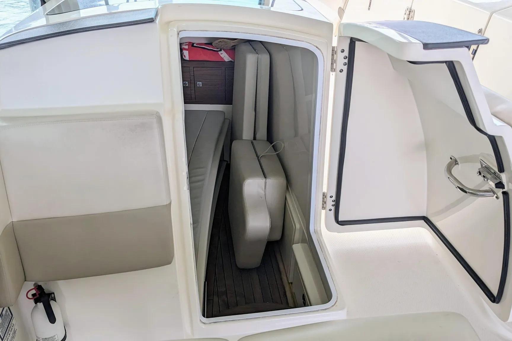 2017 Boston Whaler 320 Vantage cabin interior with seating and storage.