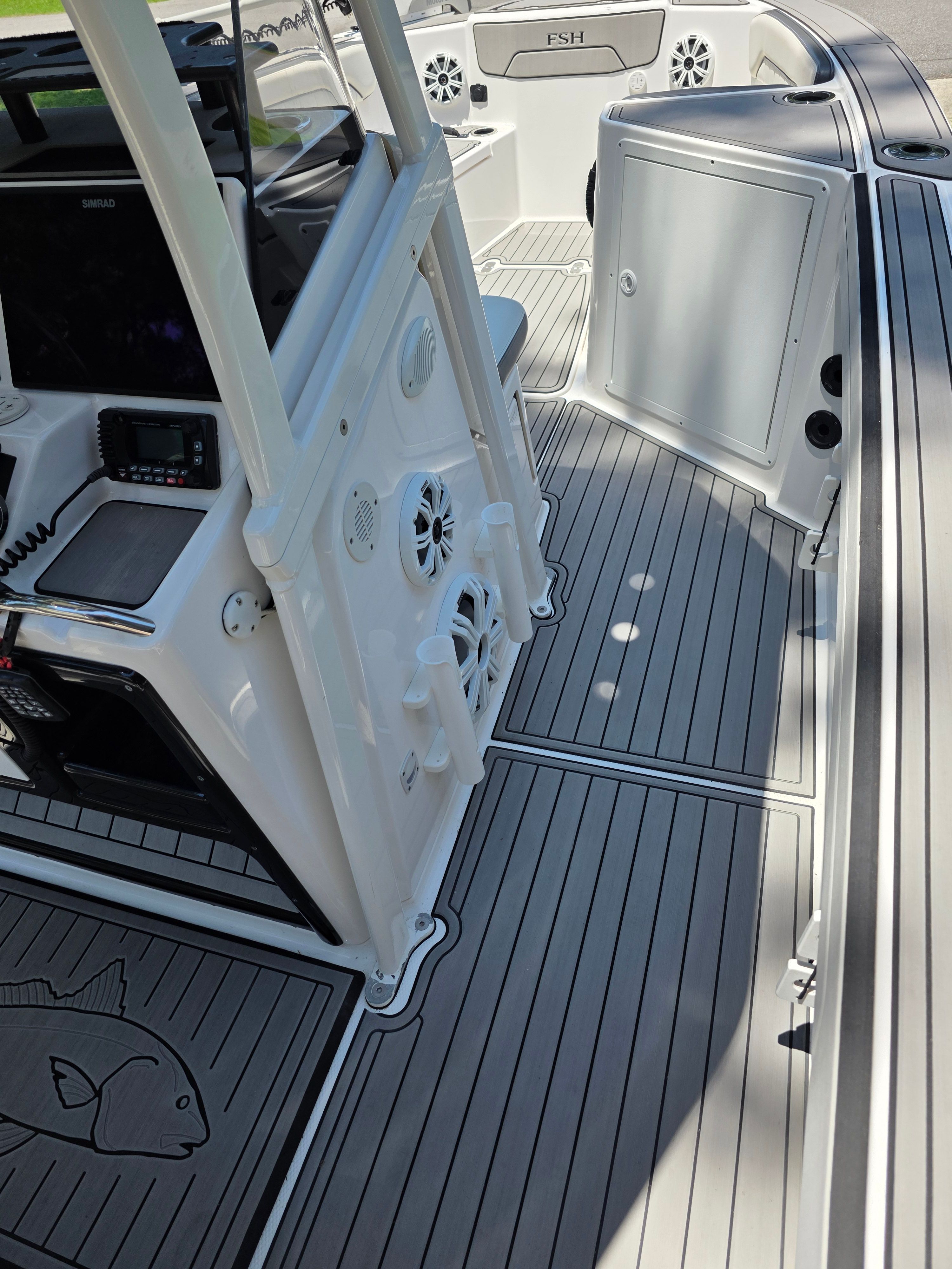 Interior of a 2020 Yamaha 210 FSH Sport boat, gray flooring.