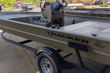 2026 Tracker Grizzly 1860 CC boat on trailer, featuring steering console and spacious deck.