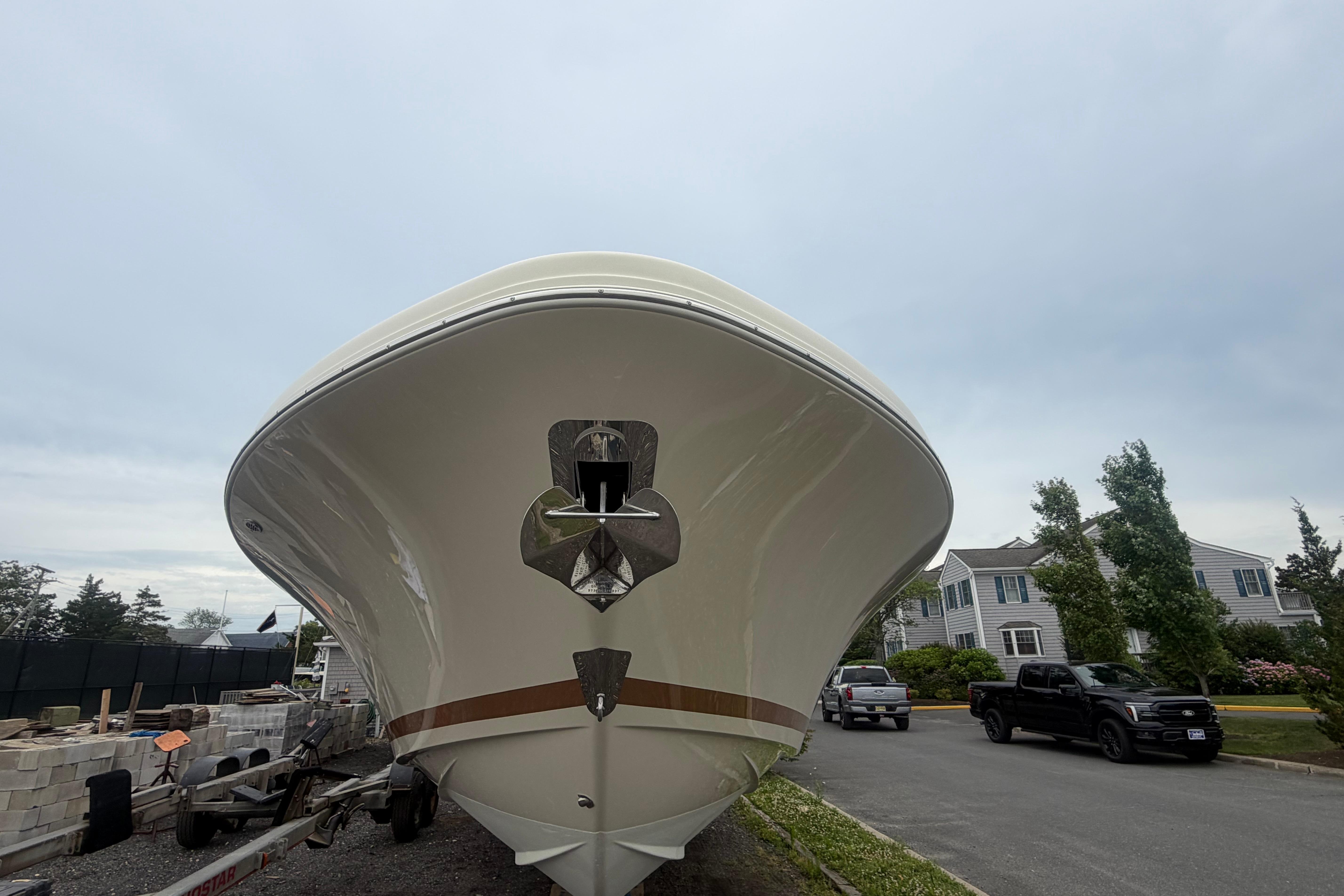 2017 Chris-Craft Catalina 34 boat on trailer, residential street background.