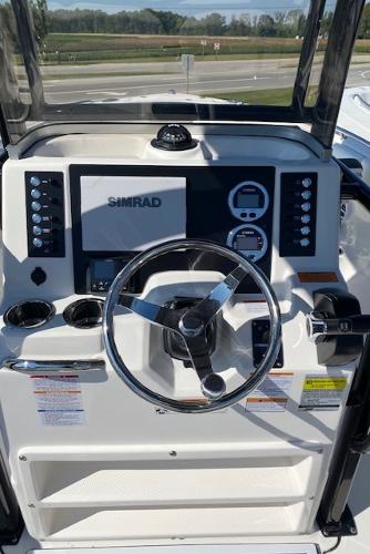 2024 Robalo R222 Center Console boat dashboard with Simrad display and steering wheel.
