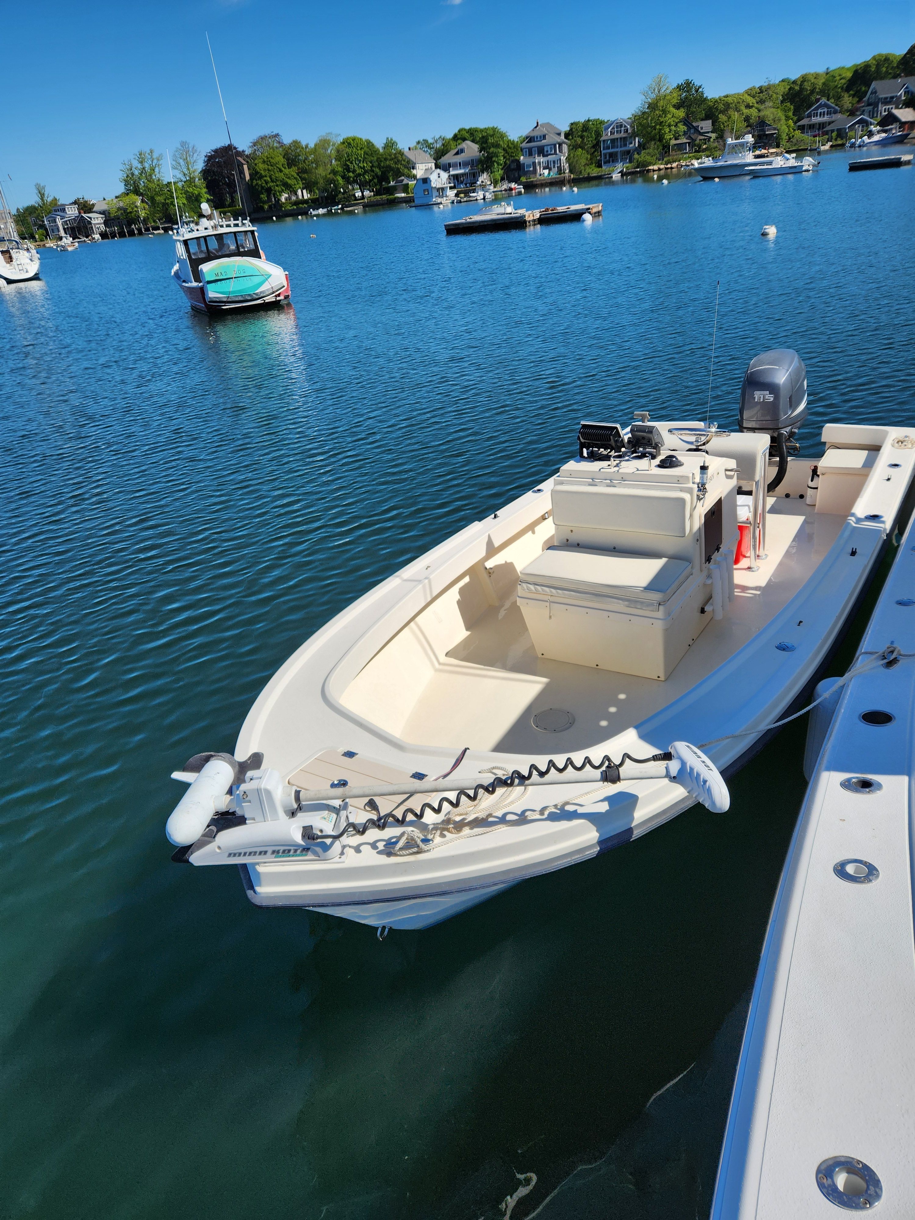 A 2004 Parker 1801 Center Console boat is docked in a calm harbor.