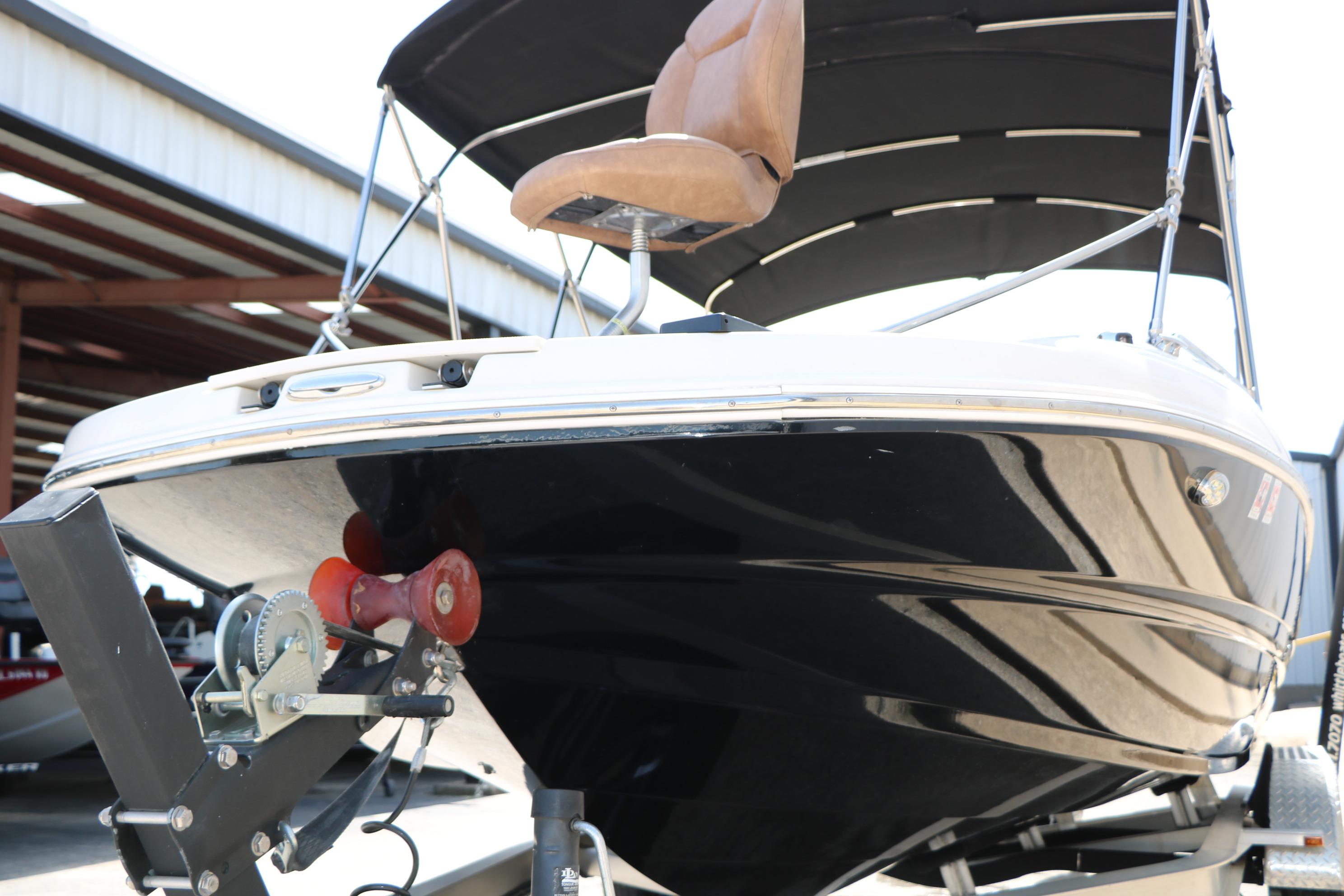 2022 Stingray 192 SC boat on trailer, featuring sleek black hull and canopy.