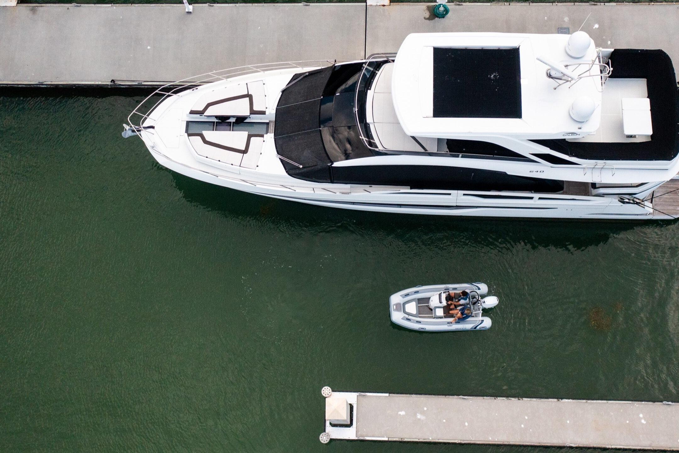 Aerial view of Highfield Classic 380 beside a yacht in the harbor.