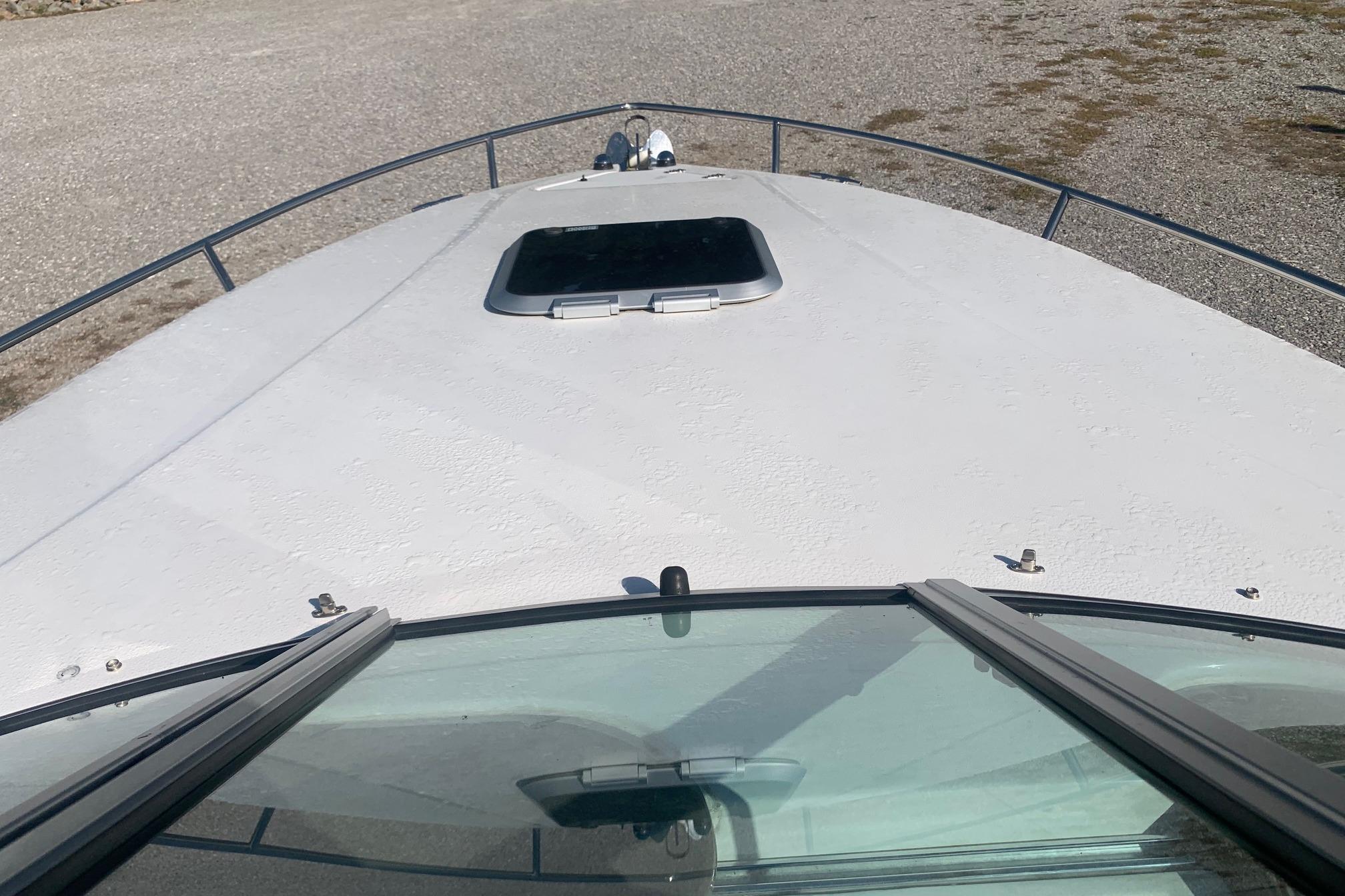 2006 Rinker 282 Captiva Cuddy boat deck with windshield and hatch view.