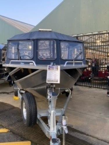 2024 Spartan 200 Astoria boat on trailer, displayed outdoors.