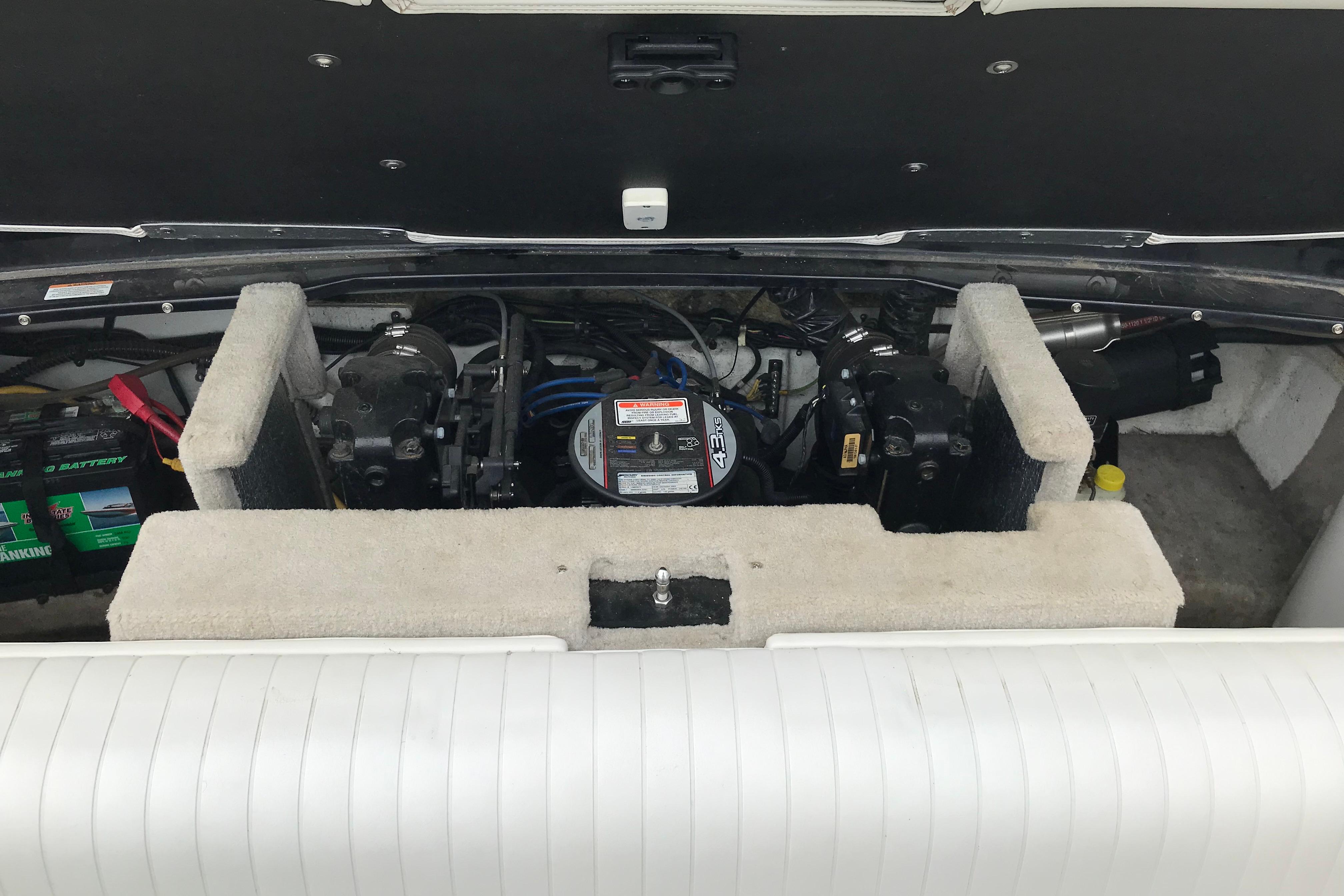 Engine compartment of a 2015 Crownline 18 SS boat, showcasing battery and mechanical components.