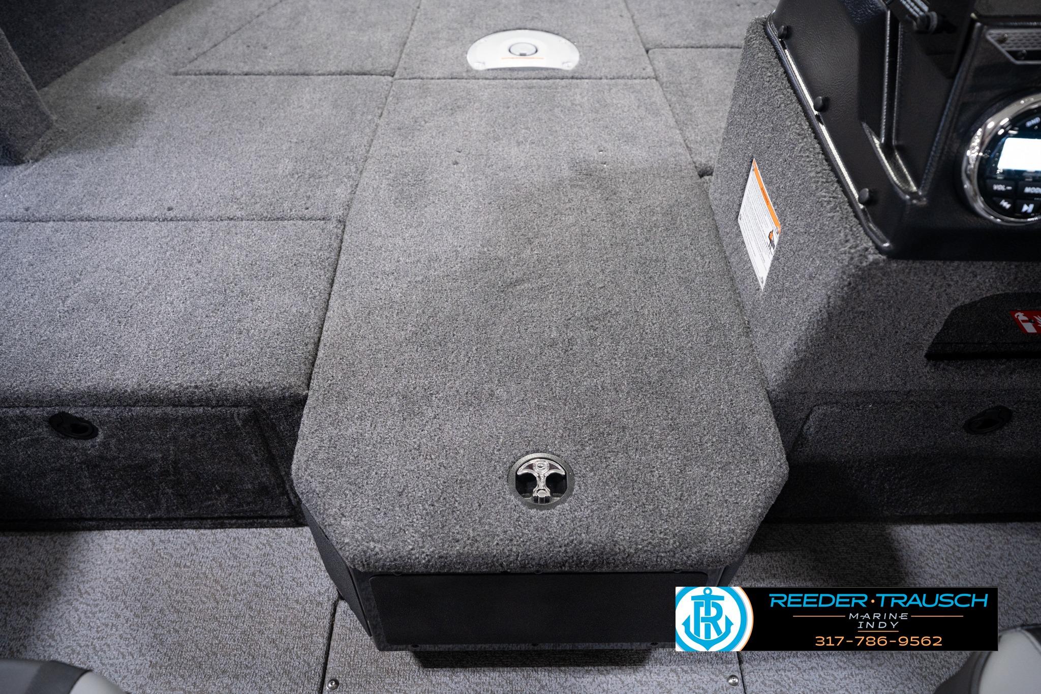 Interior view of 2026 Lund 1775 Impact XS SS boat, featuring carpeted flooring and storage compartments.