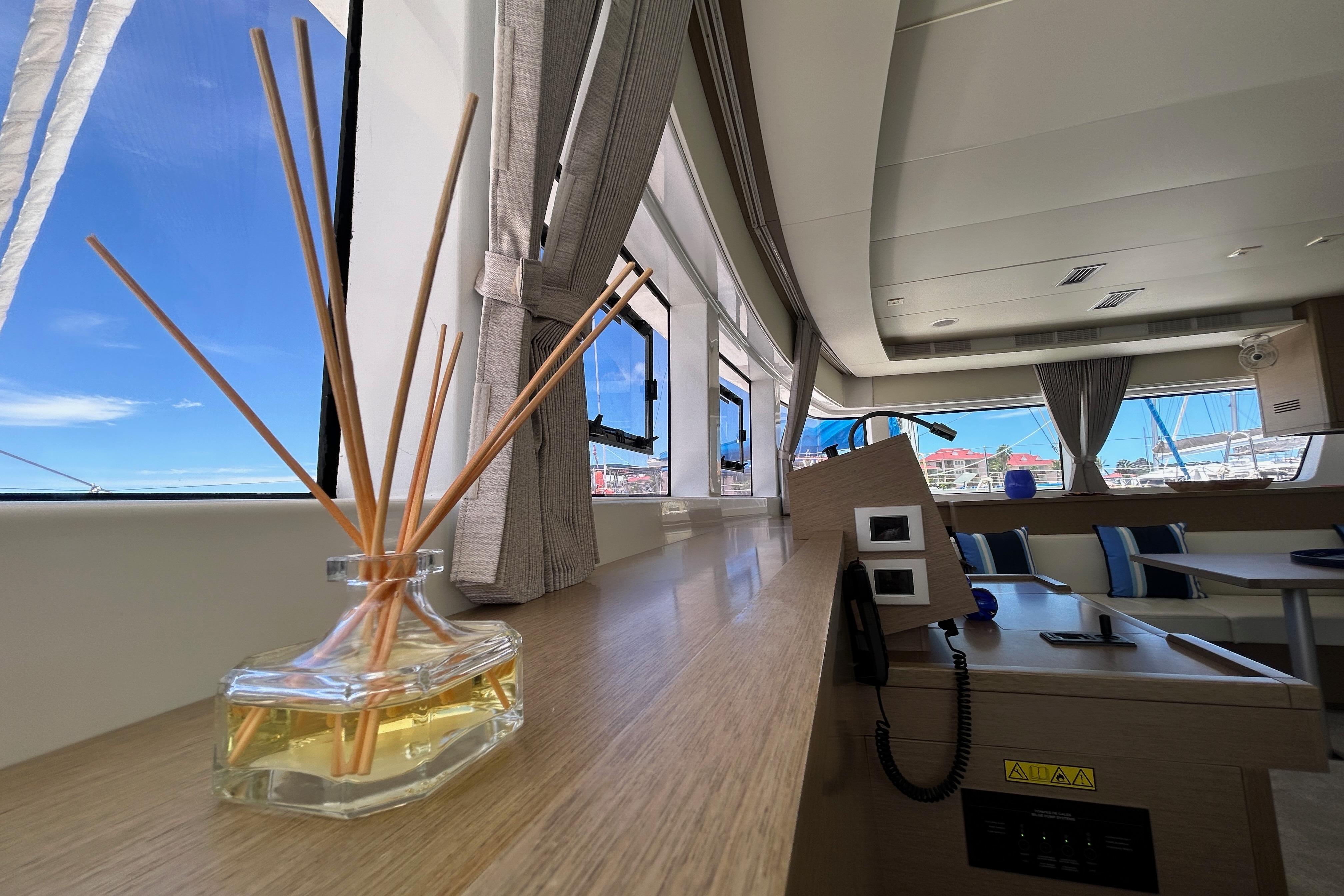 Interior of 2021 Lagoon 52 S yacht with elegant decor and large windows.