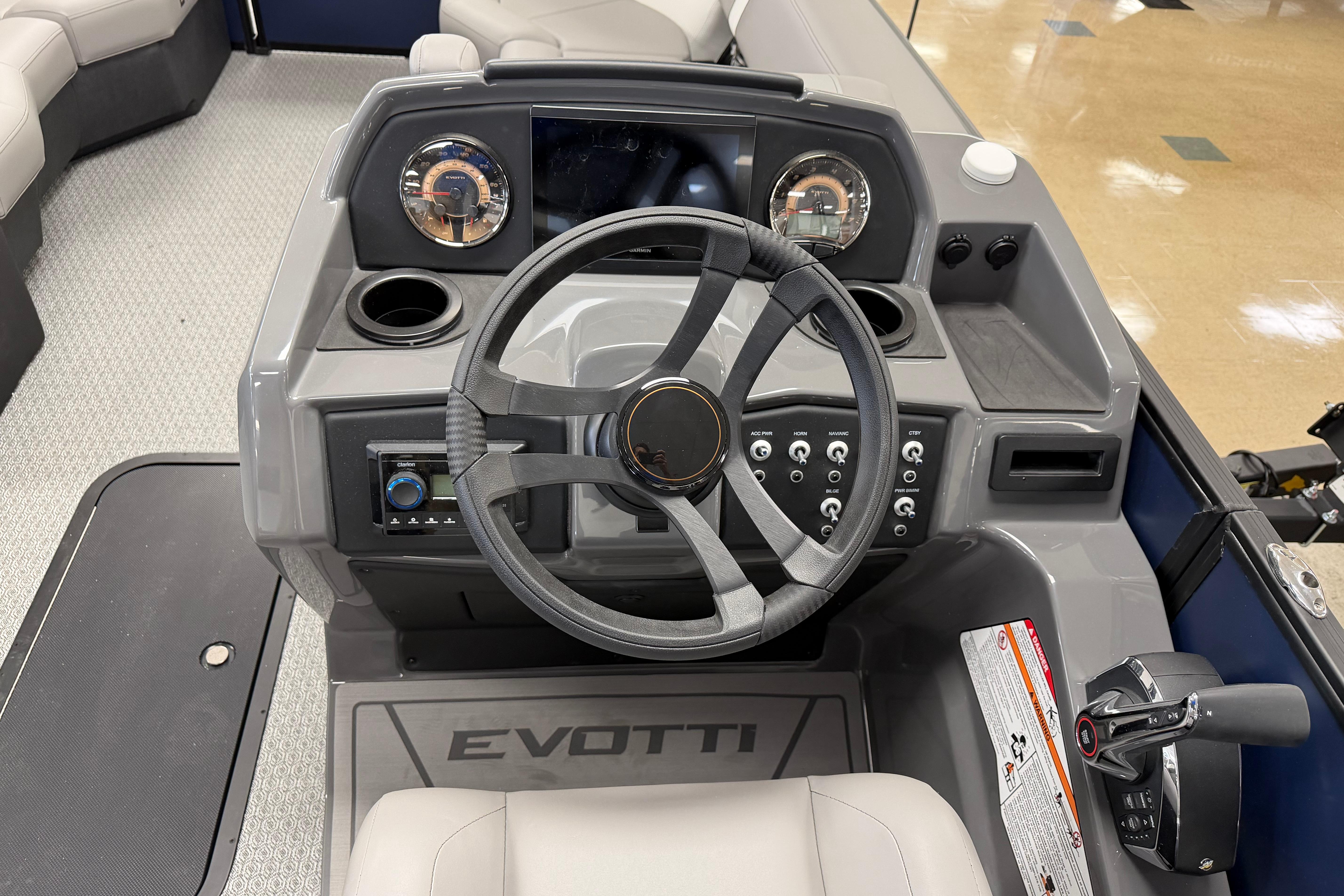 Steering console of 2026 Evotti 523QL boat with modern controls and dashboard.