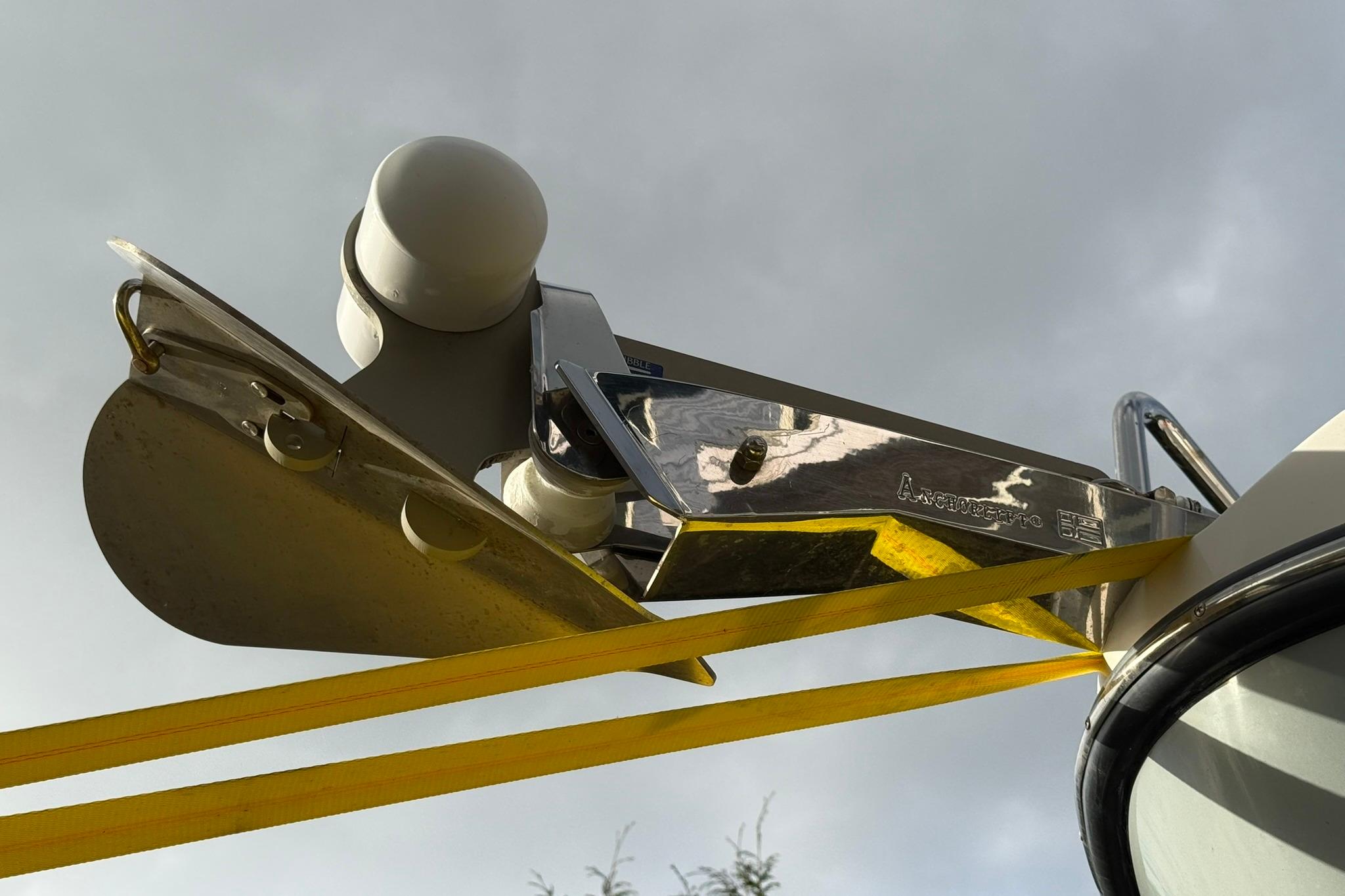 Close-up of a 2020 SeaPiper 35 boat anchor mechanism against a cloudy sky.