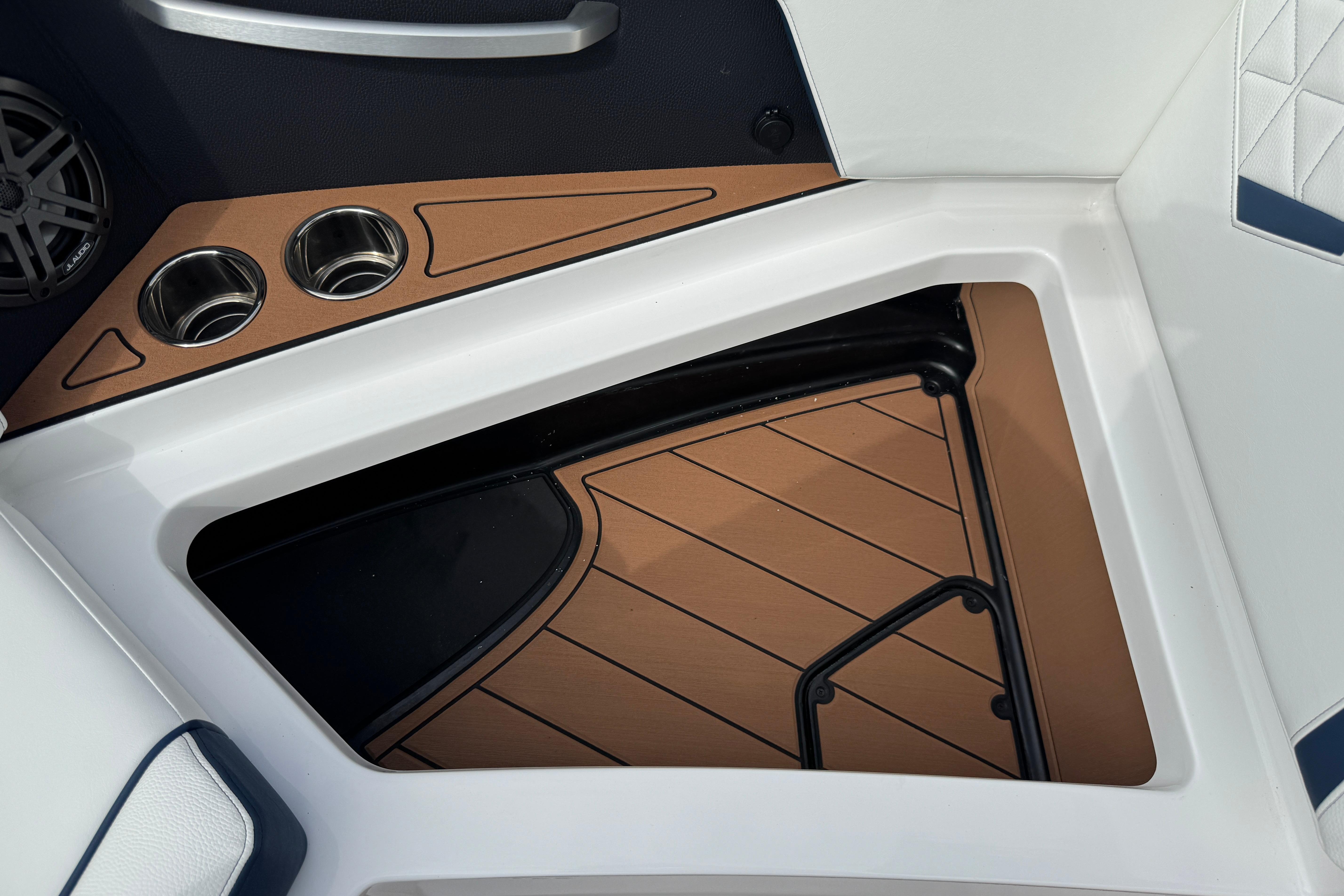2026 Nautique Super Air Nautique GS22 interior with cup holders and speaker detail.