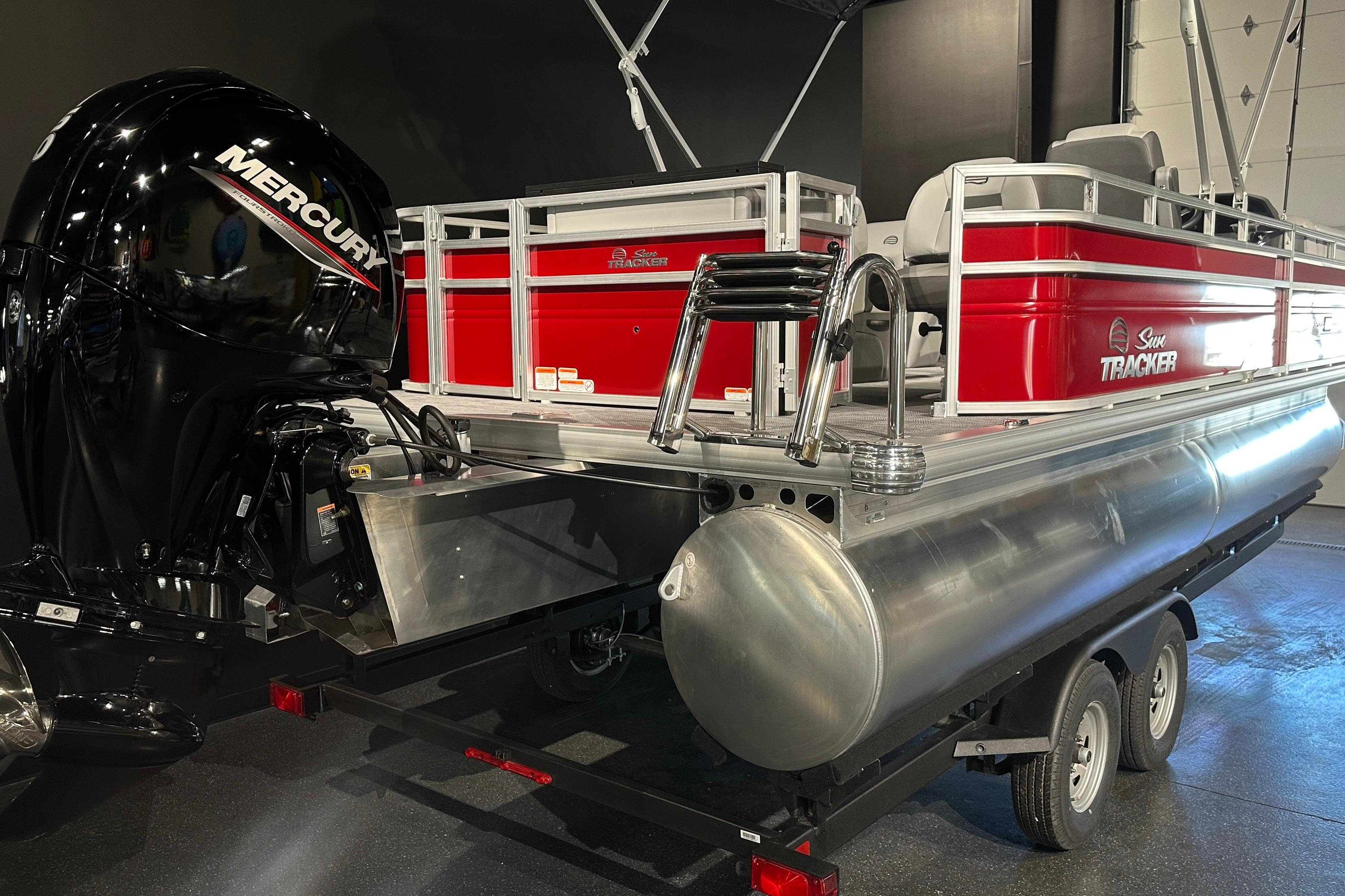 2026 Sun Tracker SportFish 22 DLX pontoon boat with Mercury engine on trailer.
