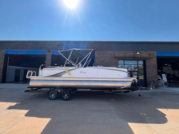 2025 Tahoe LTZ QL pontoon boat parked outside a store.
