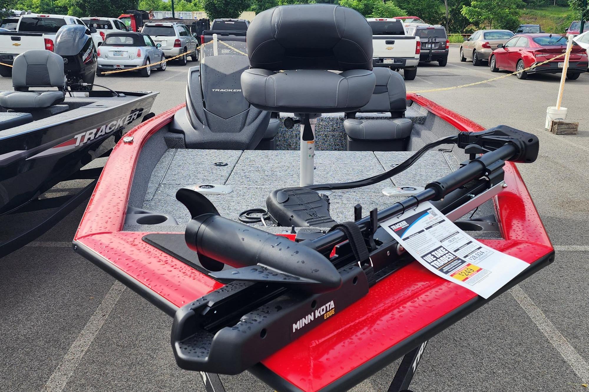 2026 Tracker Pro Team 175 Crappie Edition boat with Minn Kota trolling motor in parking lot.