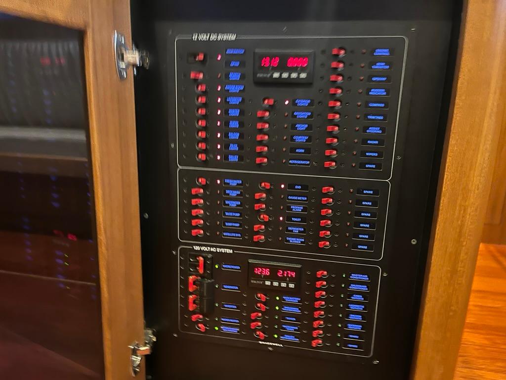 Electrical control panel inside a 2025 Bracewell 41 boat, featuring switches and indicators.