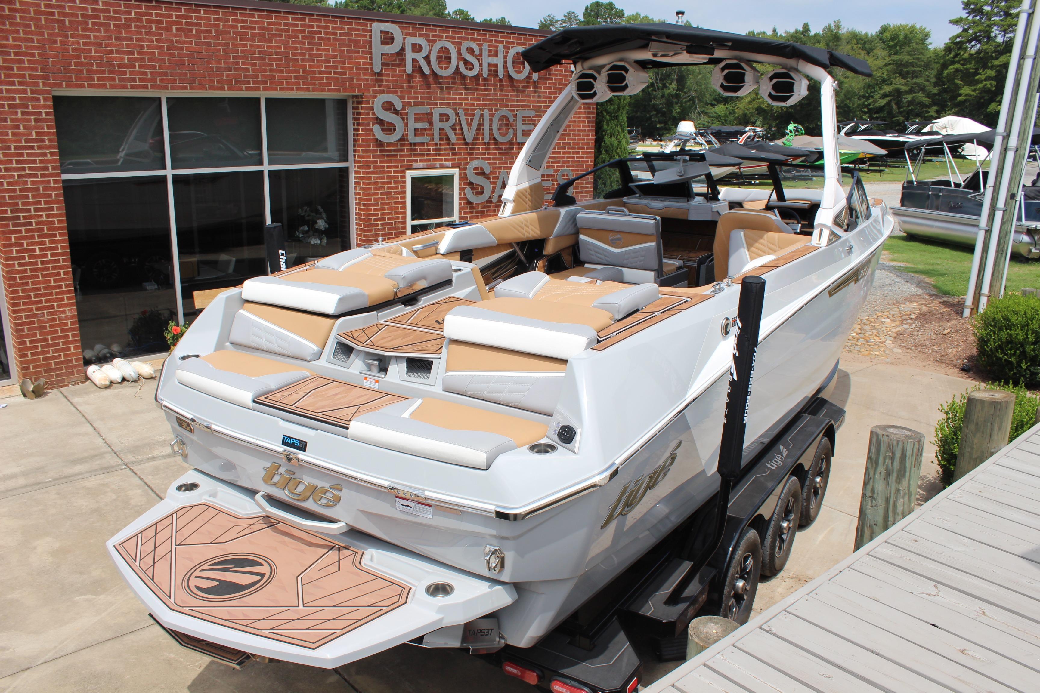 2024 Tigé Ultré 25ZX boat with sleek design, parked at a service center.