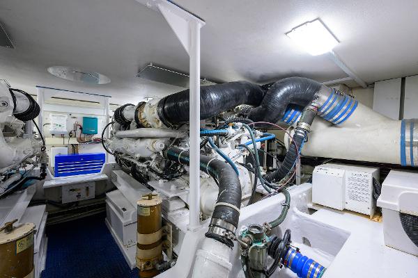 Engine room of the 2000 Viking 50 Convertible with complex piping and machinery.