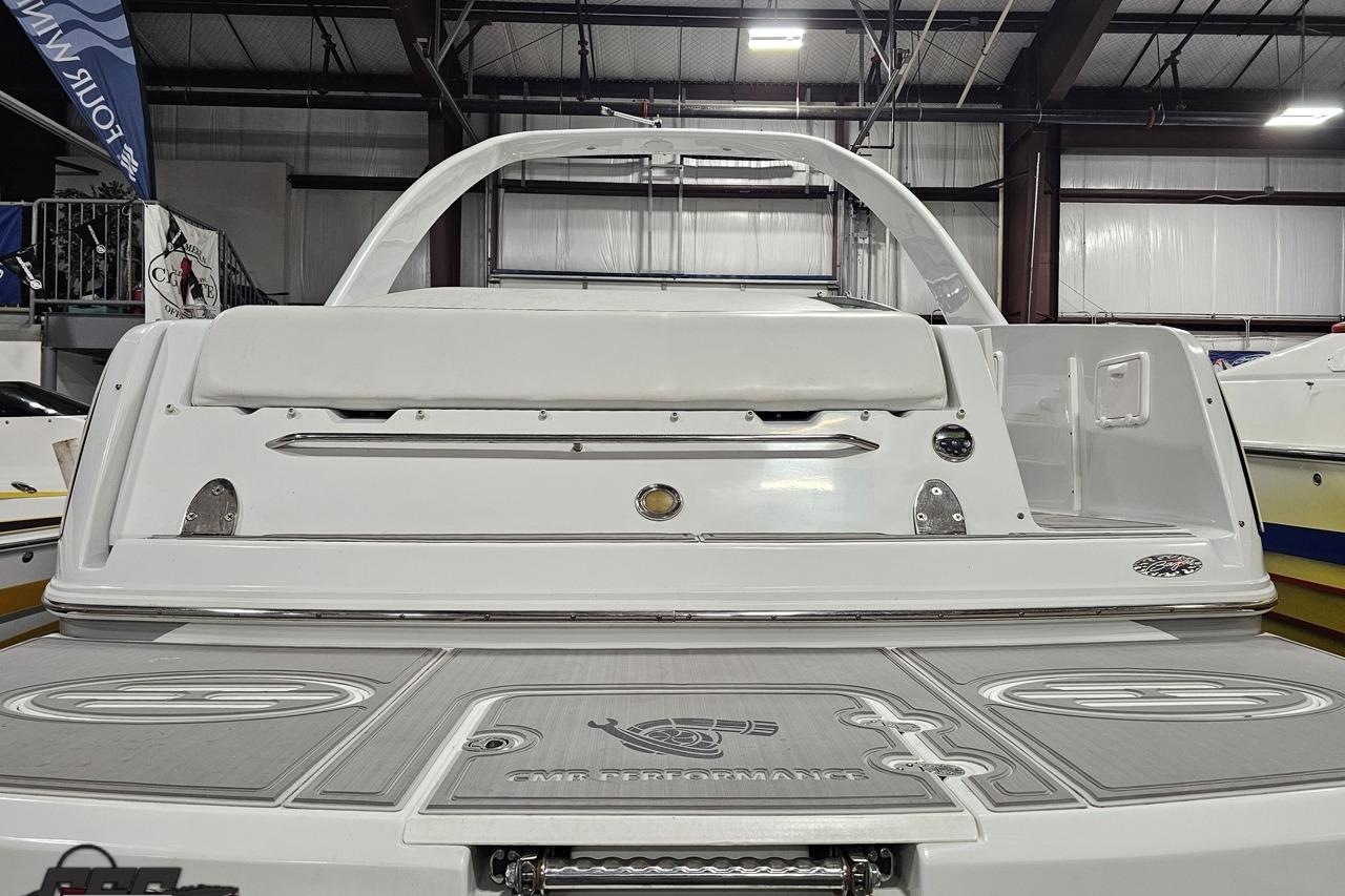 2008 Baja 335 Performance boat, rear view in indoor showroom setting.