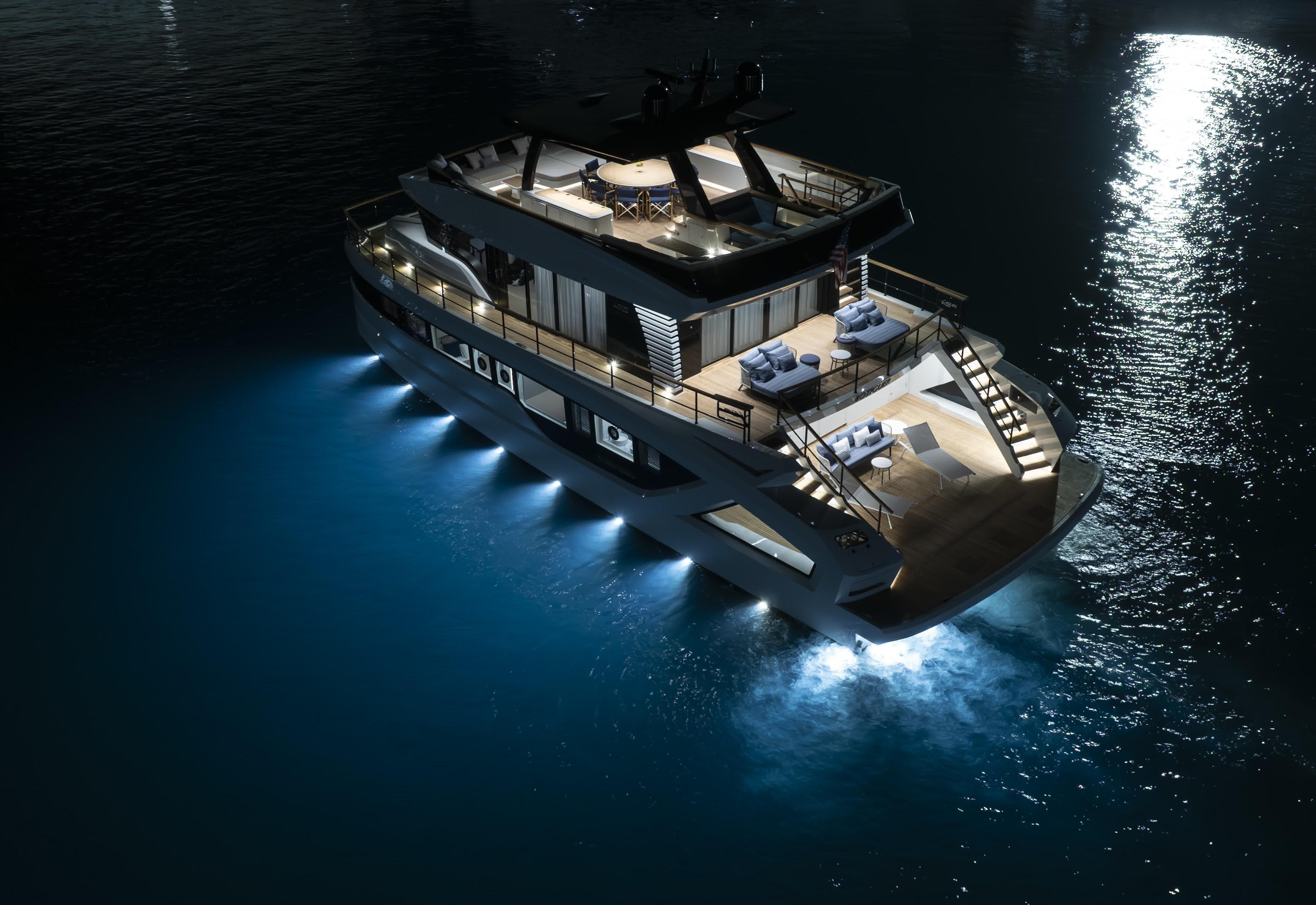 Luxurious 2027 Lazzara LPC 300 yacht illuminated at night on calm waters.