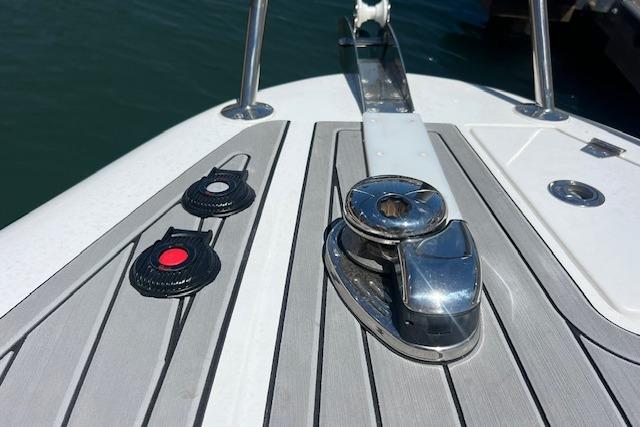 2024 Bracewell 25 boat deck with cleat and control buttons.