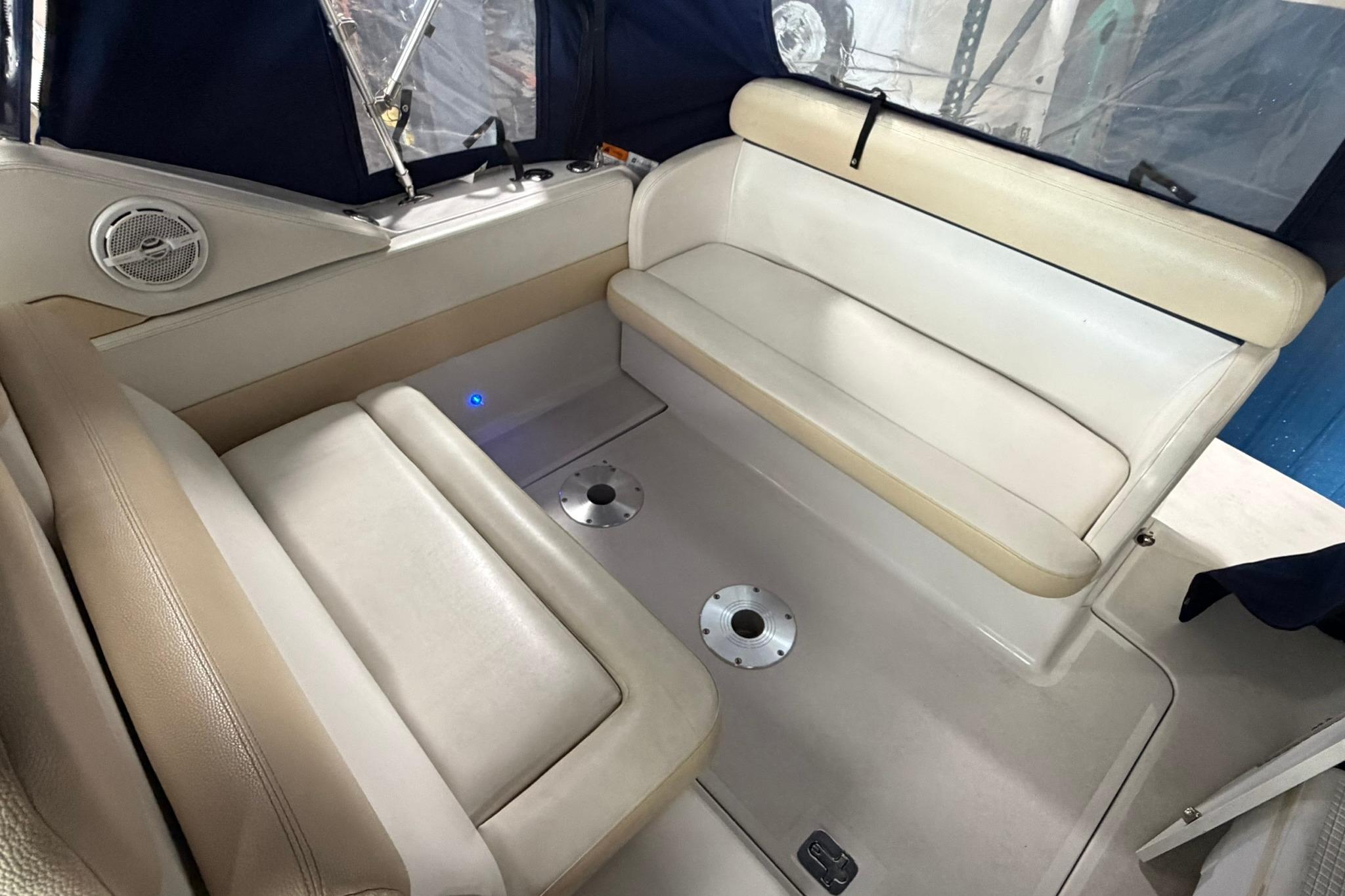 2008 Four Winns V248 boat interior with beige seating and blue accents.
