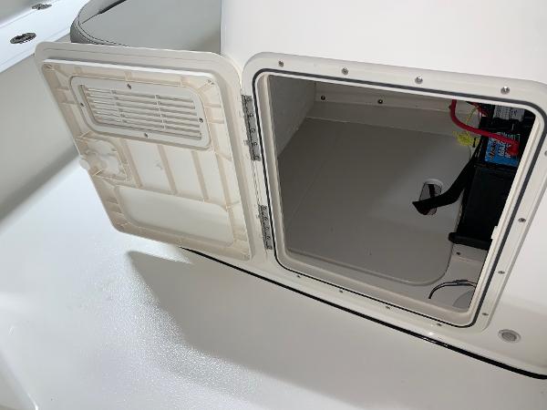 2026 Key West 188 Bay Reef boat storage compartment with open hatch and visible battery.