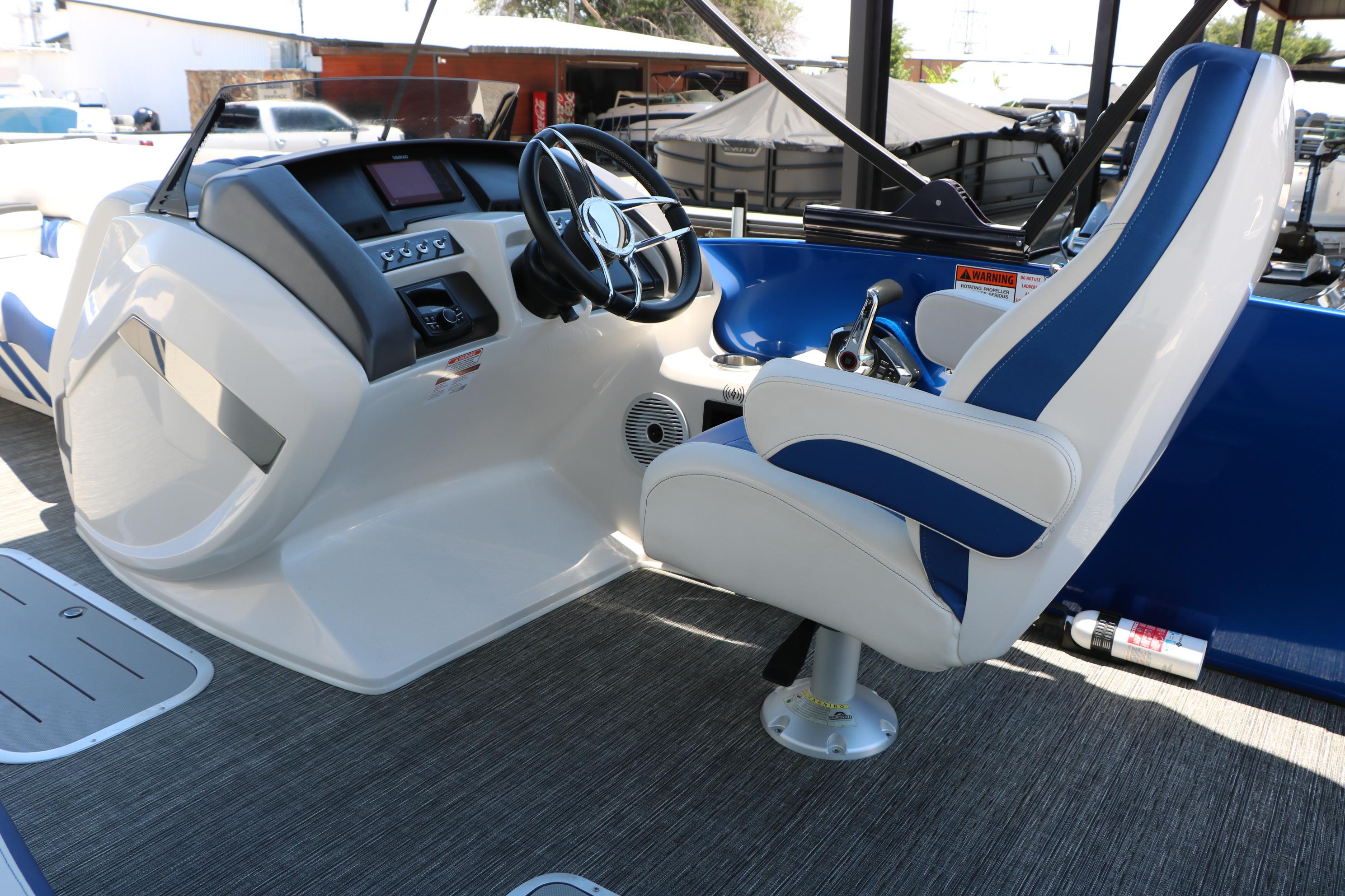 2024 Bennington 23 RX Swingback boat interior with steering wheel and captain's chair.