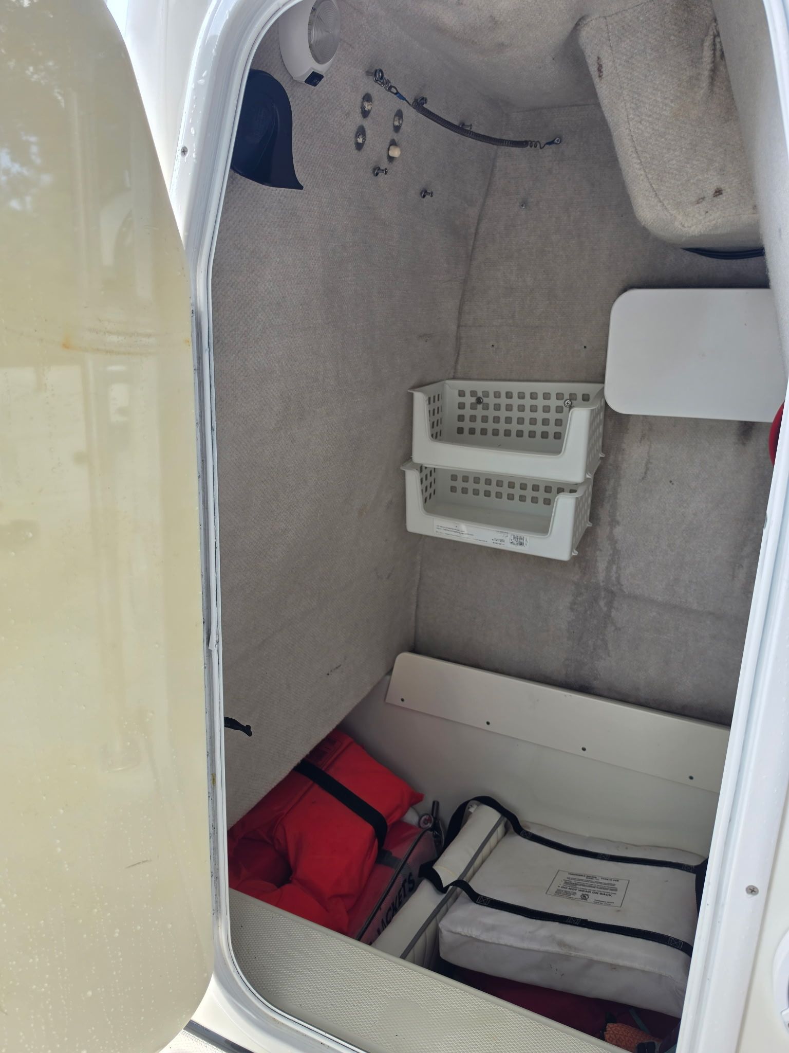 Interior of a 2004 Hydra-Sports Lightning 230 CC boat with storage and safety equipment.