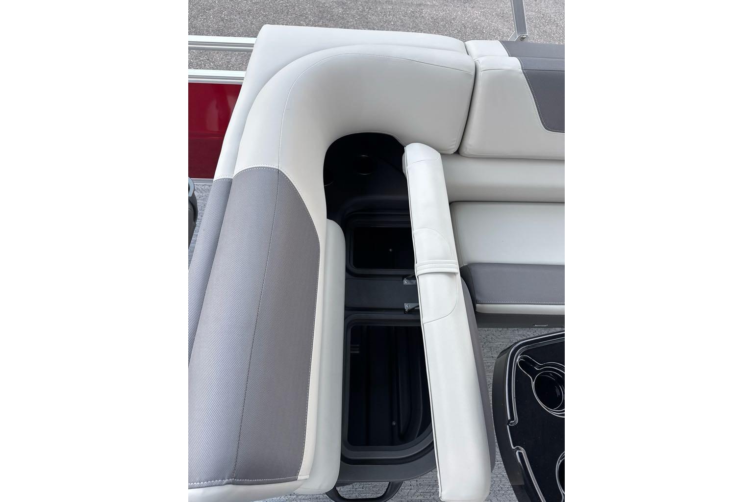 2026 Sun Tracker Fishin' Barge 22 DLX boat seat with storage compartment open.