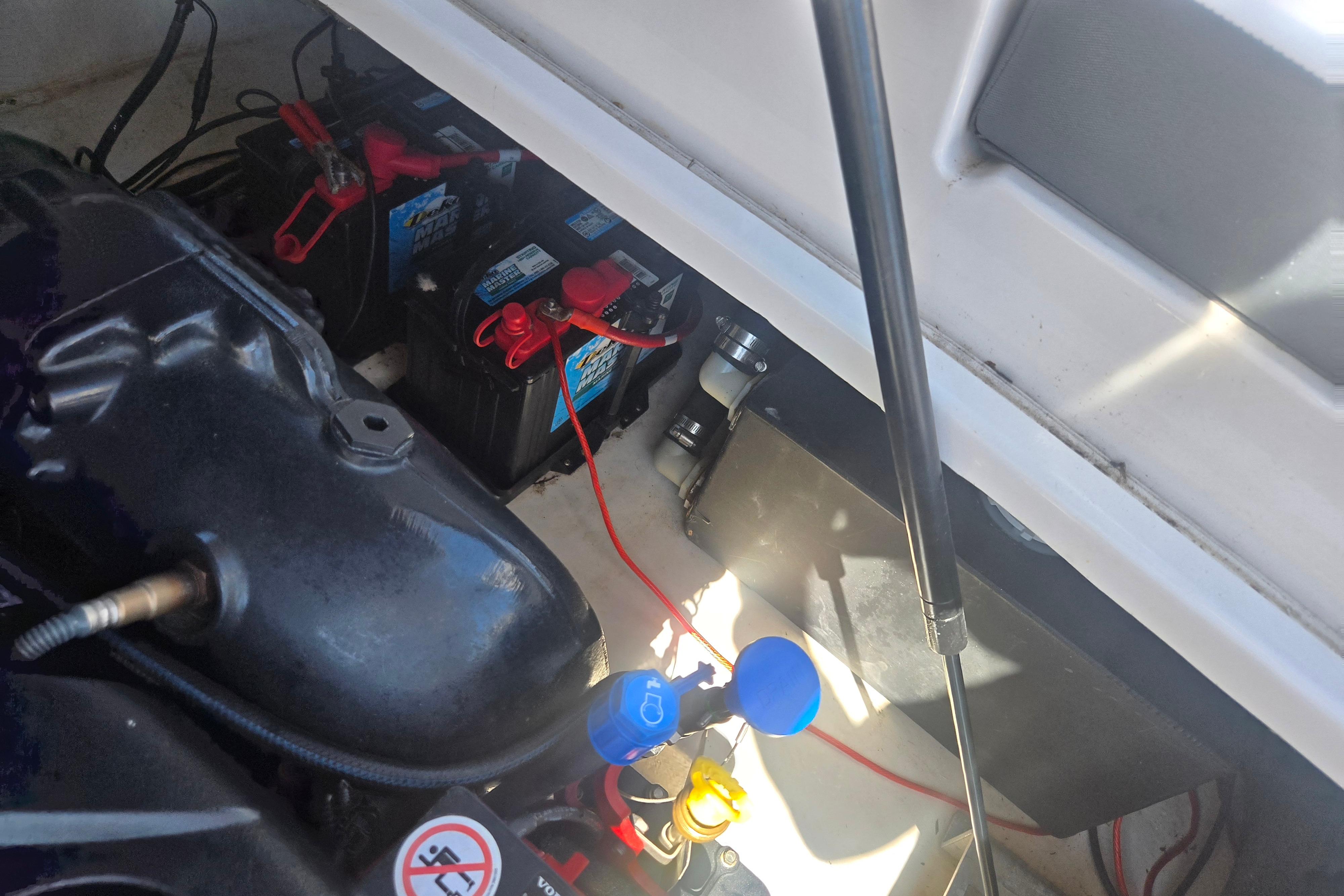 Engine compartment of 2018 Chaparral 267 SSX boat showing batteries and wiring.