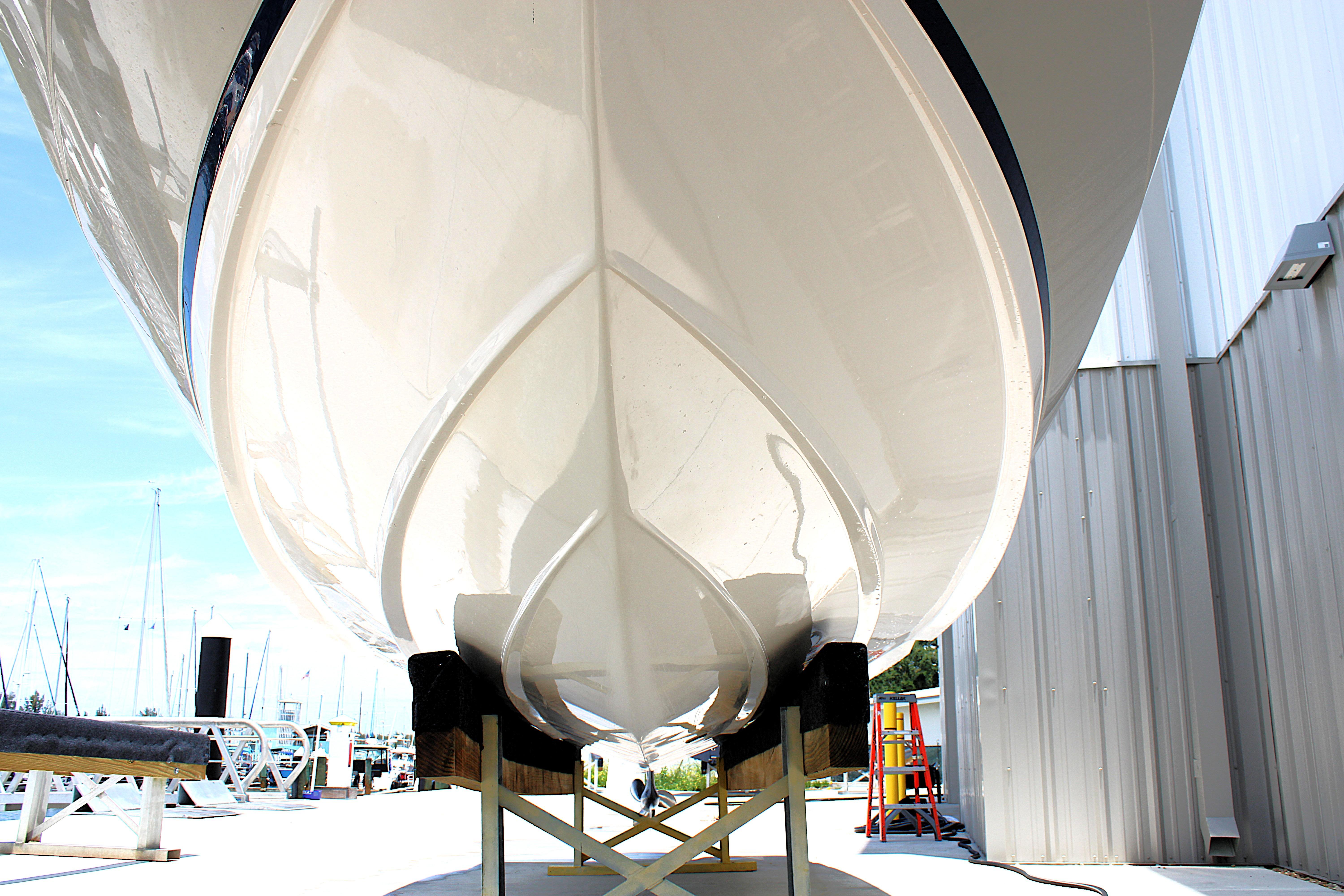 2021 Regal 26 OBX boat hull on display at a marina.