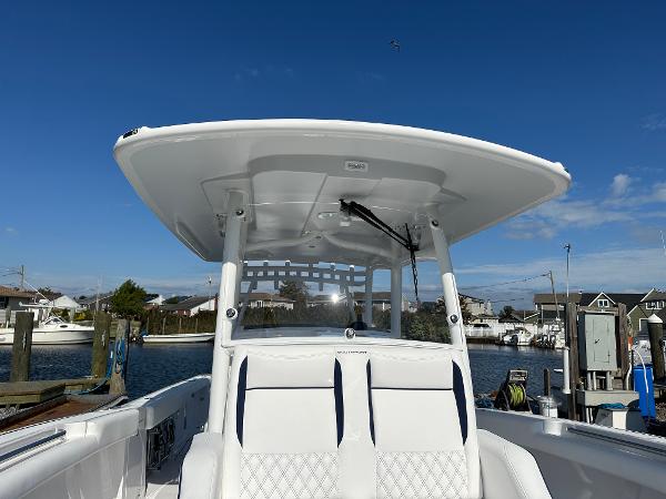 2025 Southport 33 DC boat with T-top, docked under clear blue sky.