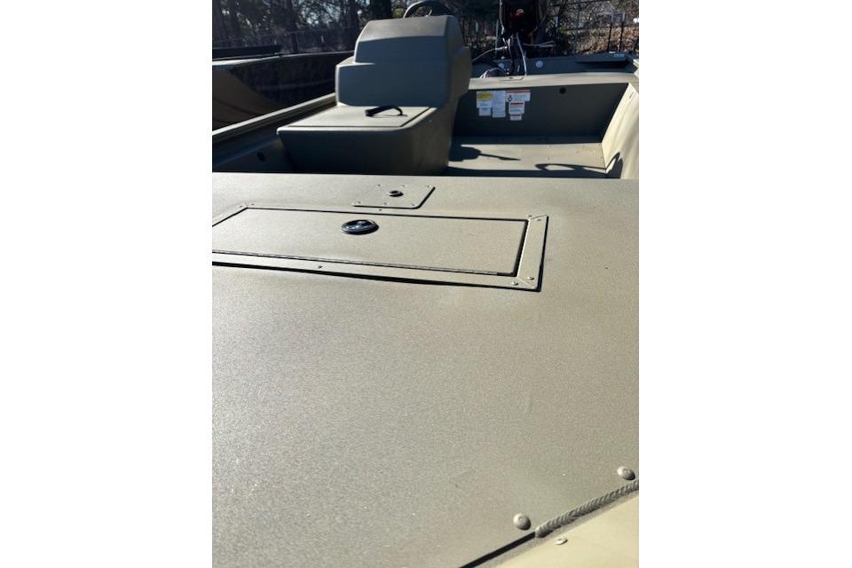2026 Tracker Grizzly 1648 SC boat interior with storage compartment and seating.