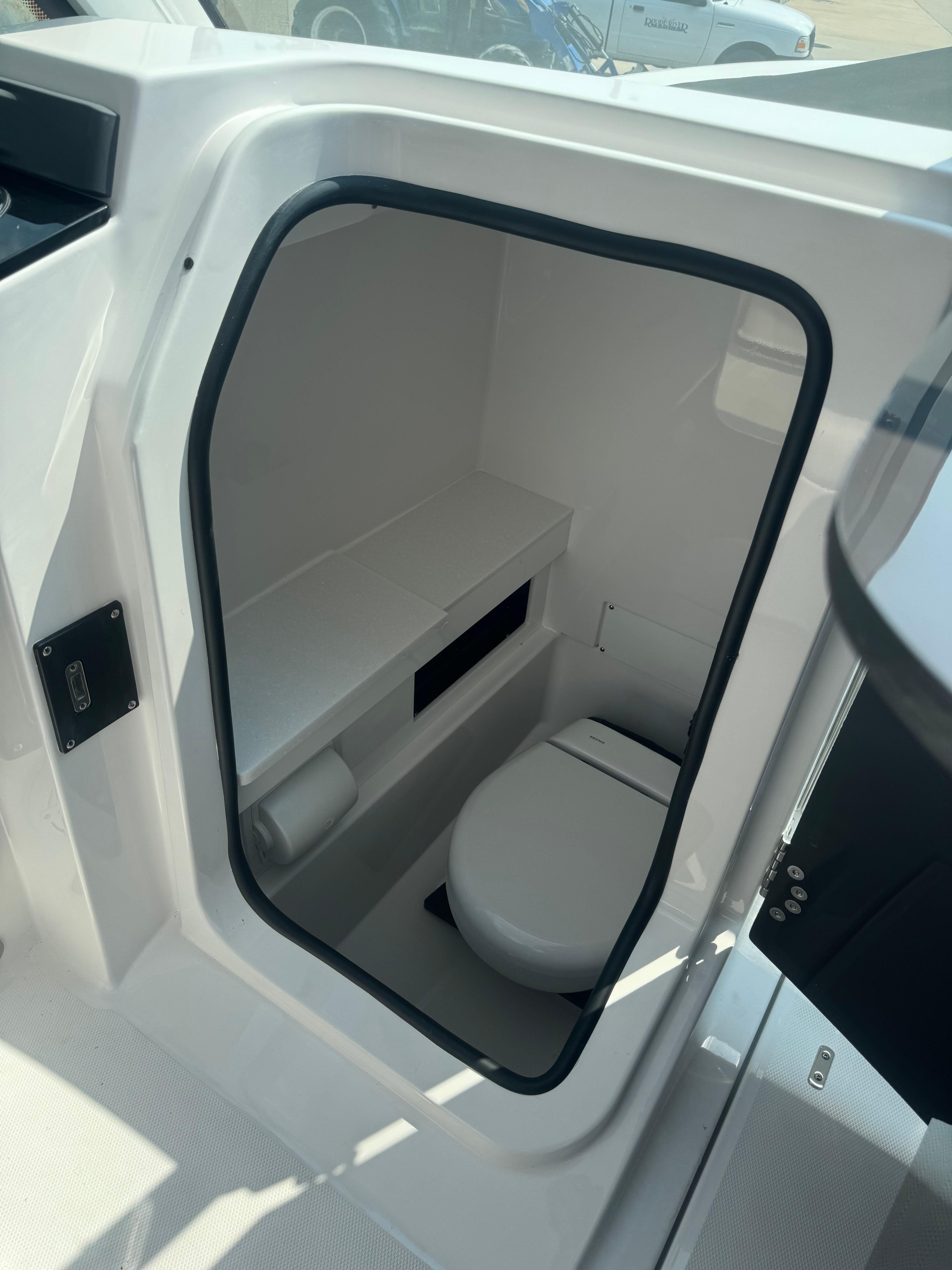 2025 Blackfin 252 DC boat interior with compact marine toilet.